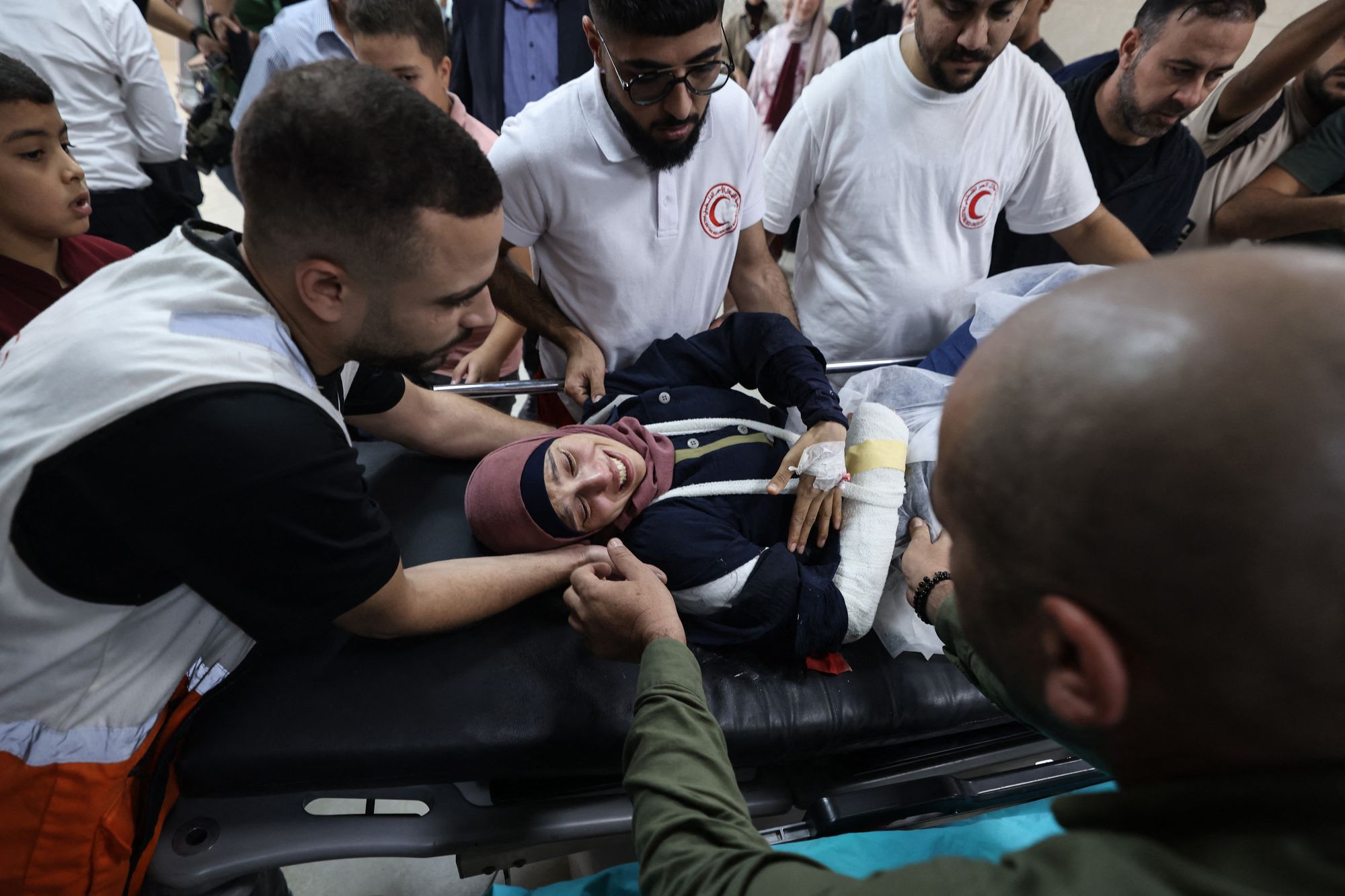 Reuters journalist Raneen Sawafta is carried on a stretcher at the Rafidia Hospital in Nablus after being injured by Israeli settlers during an attack at the Palestinian village of Baita in occupied West Bank