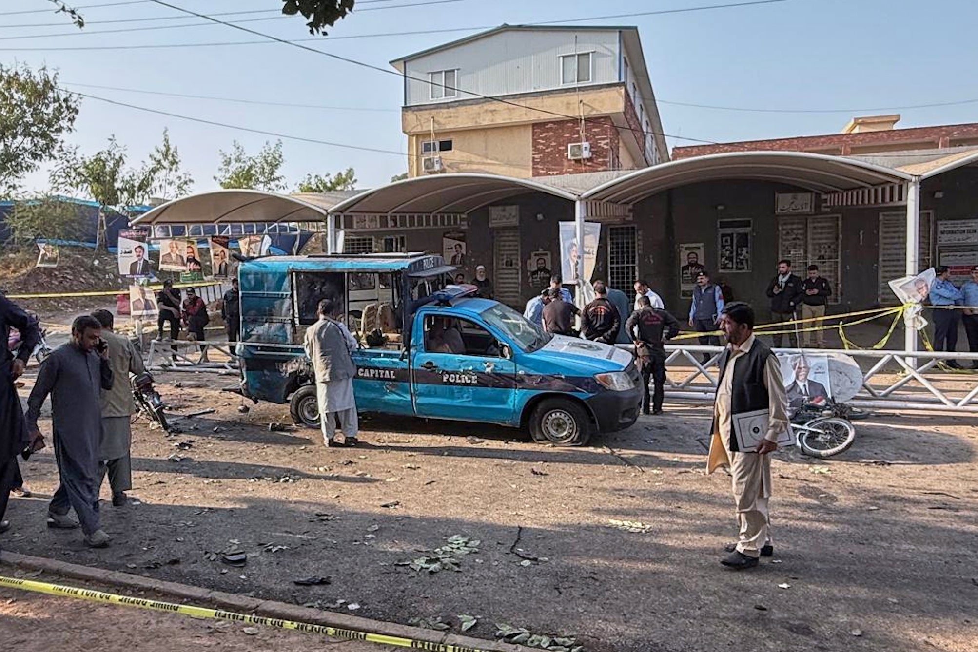 Security officials examine a damaged vehicle following a suicide bombing in Islamabad, Pakistan, on 11 November 2025