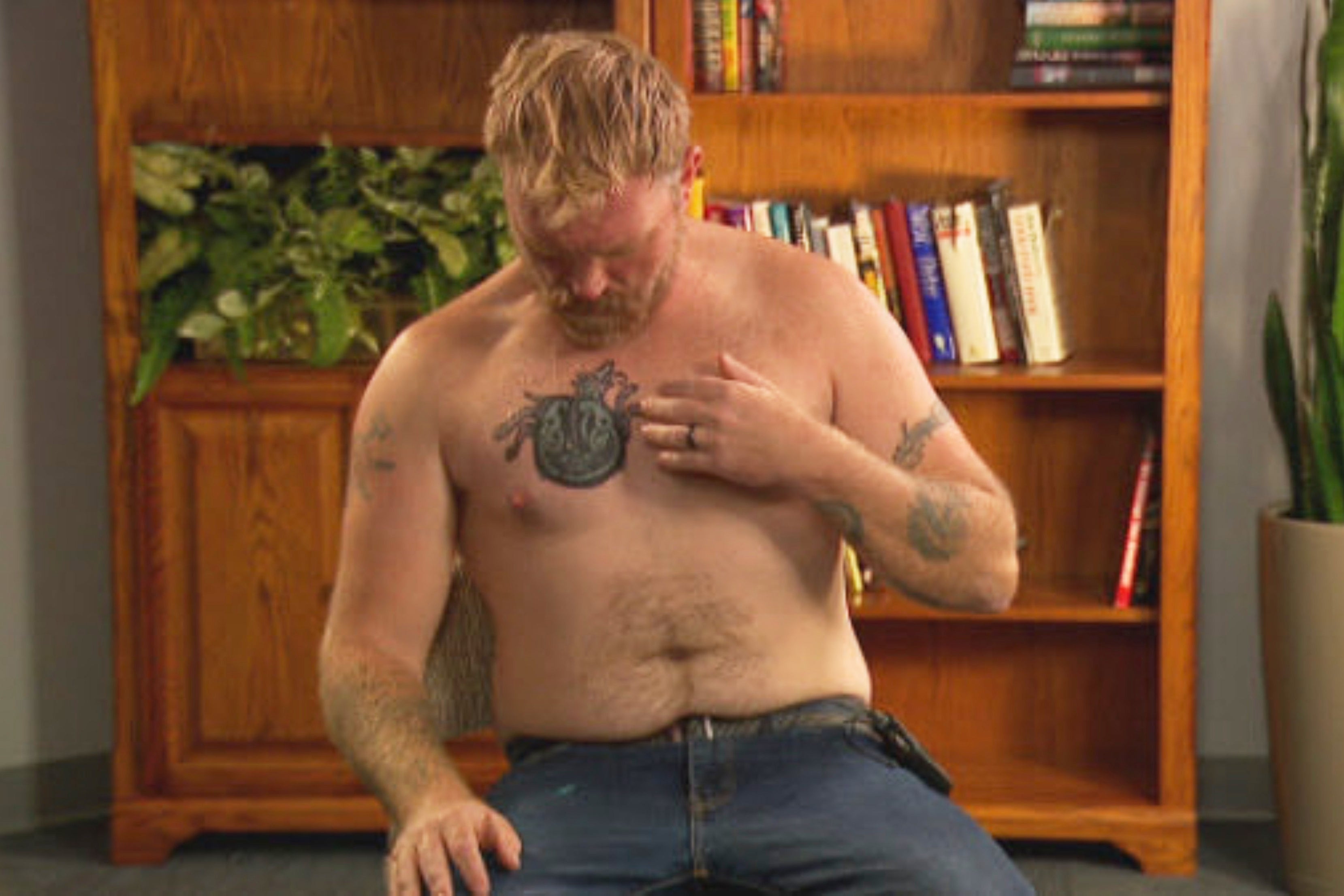 In this photo provided by WGME, Graham Platner, a democratic candidate for U.S. Senate, points to a cover-up tattoo that had previously been an image recognized as a Nazi symbol