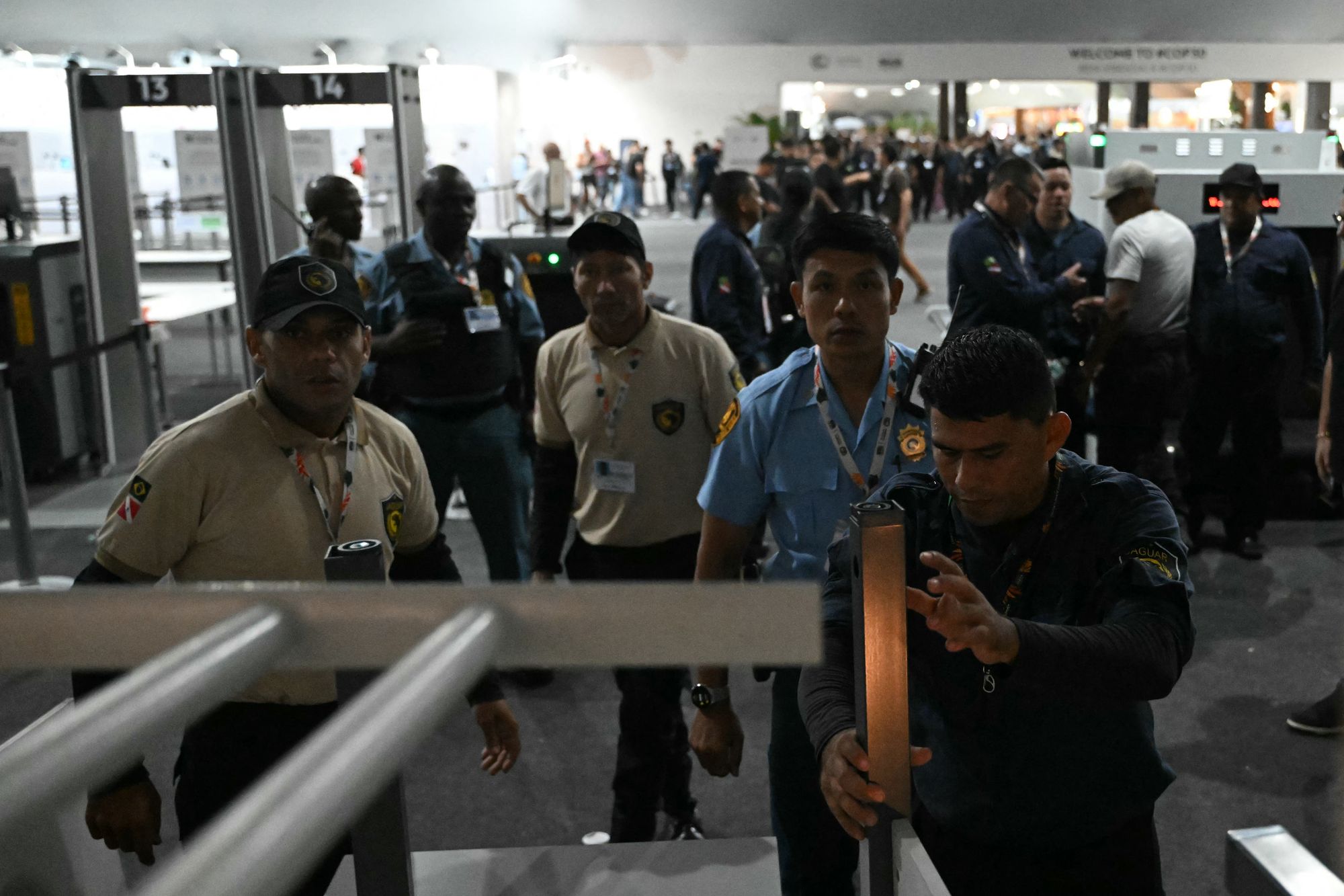Security personnel block entrance doors as Indigenous people and students attempt to storm the venue during the COP30 UN Climate Change Conference in Belem, Para State, Brazil, on November 11, 2025. (Photo by Mauro PIMENTEL / AFP) (Photo by MAURO PIMENTEL/AFP via Getty Images)
