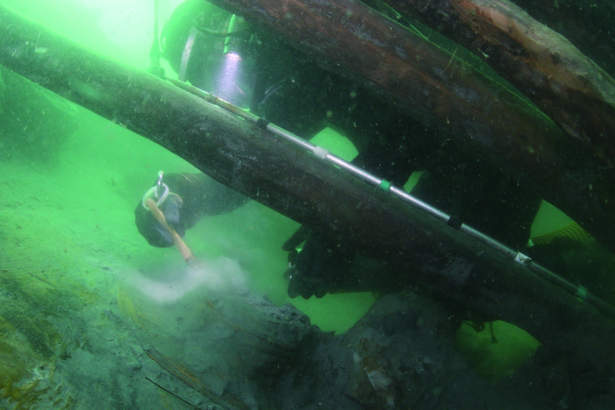 <p>Pictures show   researcher examining the Mado 4 shipwreck  </p>