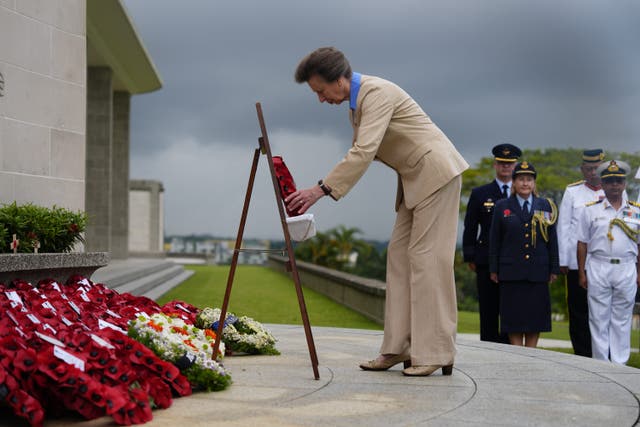 The Princess Royal, President of the Commonwealth War Graves Commission (CWGC), and Vice Admiral Sir Tim Laurence, lays a wreath during Service of Remembrance at the Kranji War Cemetery in Singapore (Jordan Pettitt/PA)