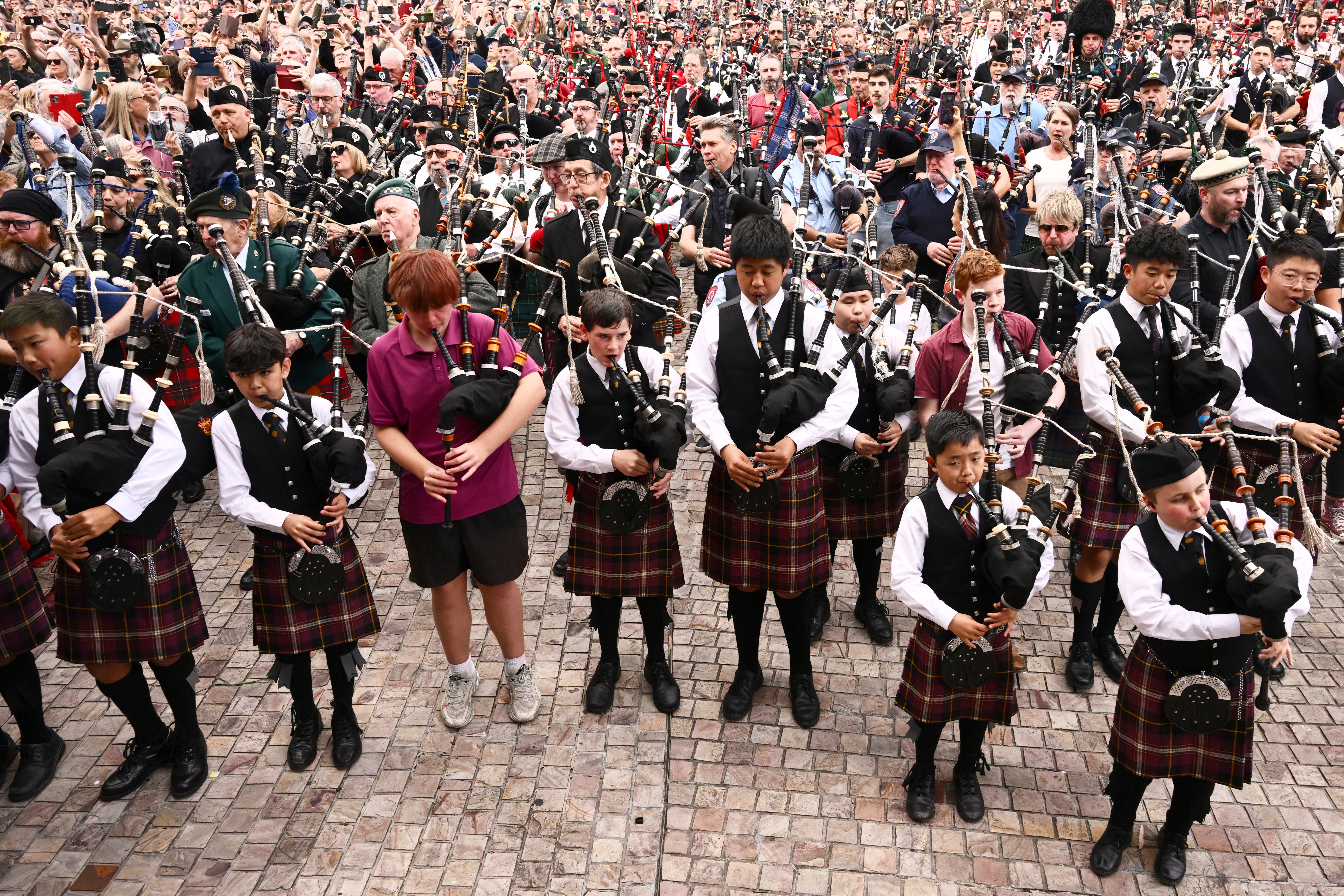 <p>Bagpipers gather to break a world record playing AC/DCs It's a Long Way to the Top </p>