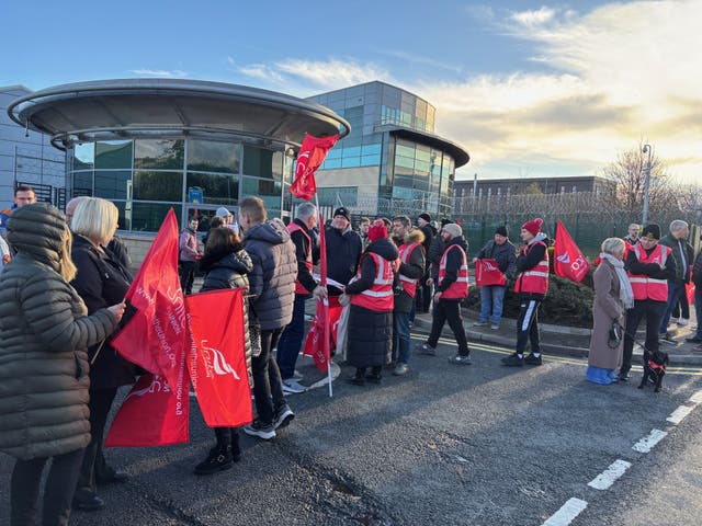 <p>Many of the striking workers outside Leonardo’s Edinburgh site waved red Unite banners</p>
