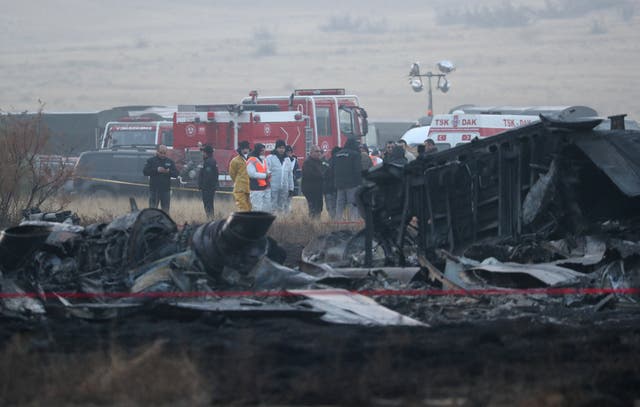 <p>Members of emergency services work at the site of the Turkish C-130 military cargo plane crash</p>