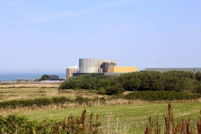 A view across fields of the old nuclear power plant at Wylfa, Anglesey, in 2022 (Alamy/PA)