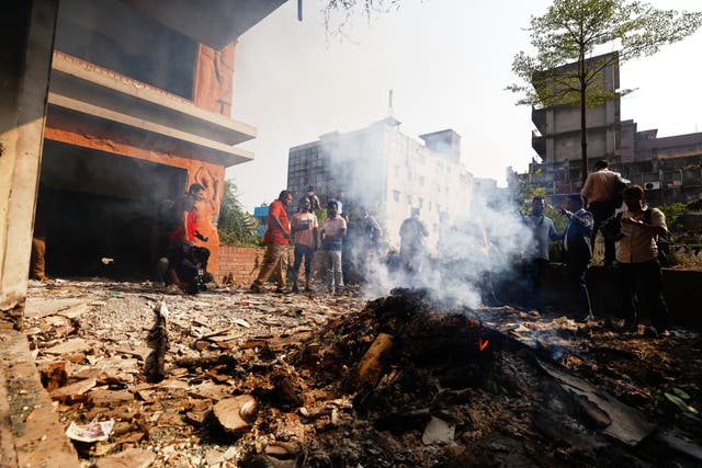 <p>A fire smolders after the party office of the Awami League party led by ousted Prime Minister Sheikh Hasina was vandalized during a nationwide "lockdown" called by Hasina's party in protest against her trial, in Dhaka, Bangladesh, Thursday, Nov. 13, 2025. (AP Photo/Mahmud Hossain Opu)</p>