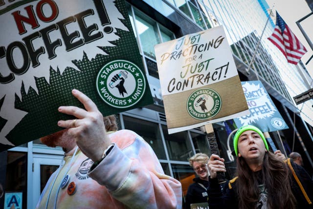 <p>Workers picket in front of a Starbucks outlet in New York City, on October 1, 2025. Unionized workers across the country were expected to walk out on the job Thursday as they claim the coffee giant refuses to reach a contract with them</p>