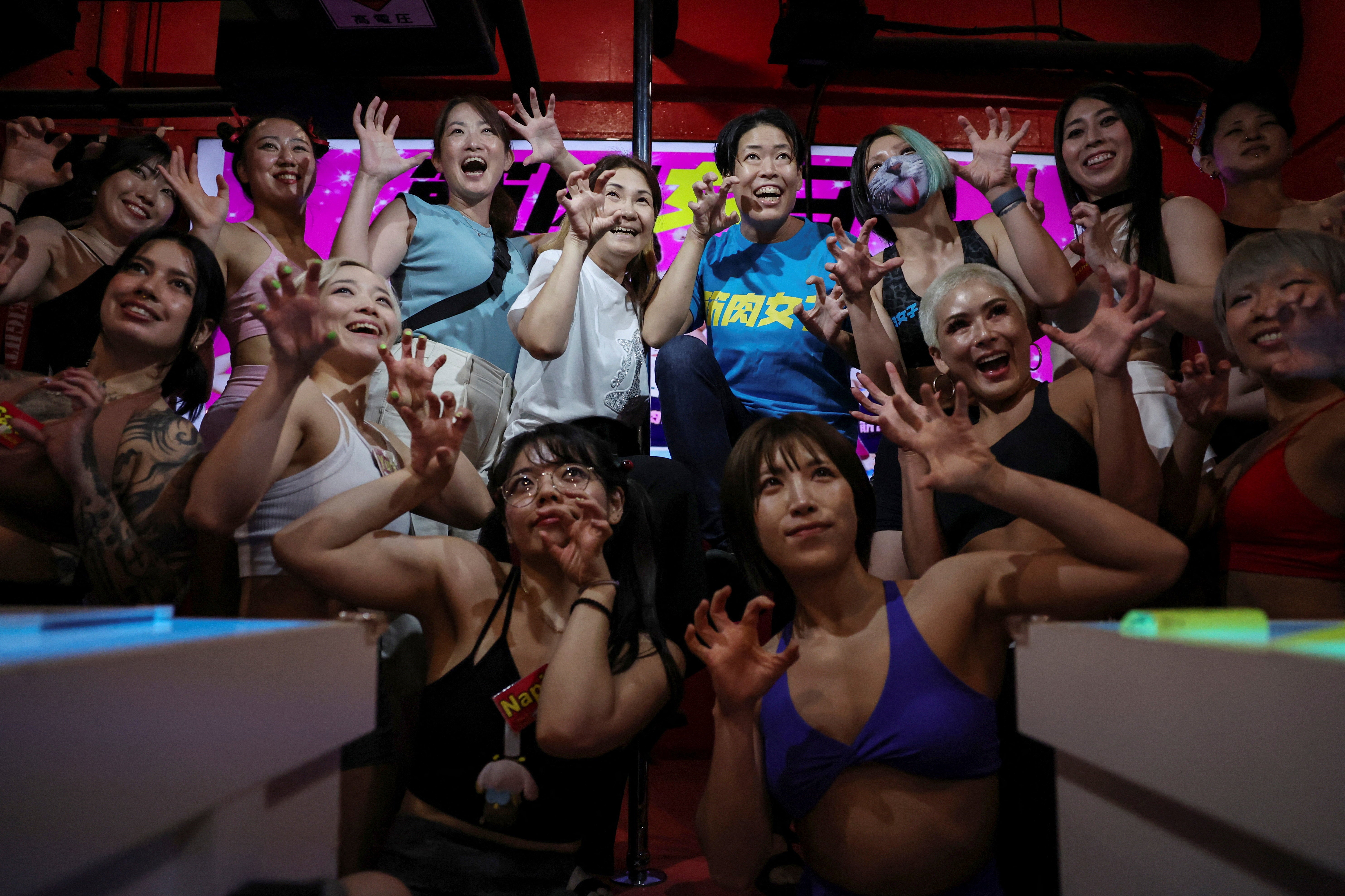 Staffers at Muscle Girls pose for a photo with female customers