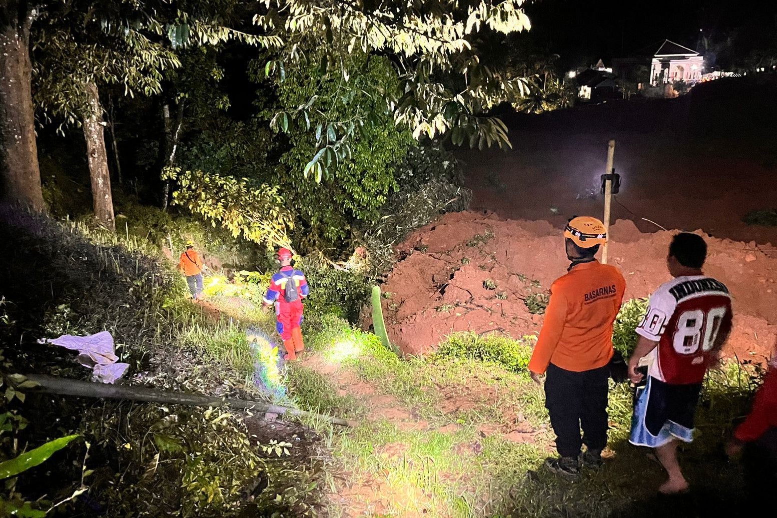<p>Rescuers search for victims after a landslide</p>