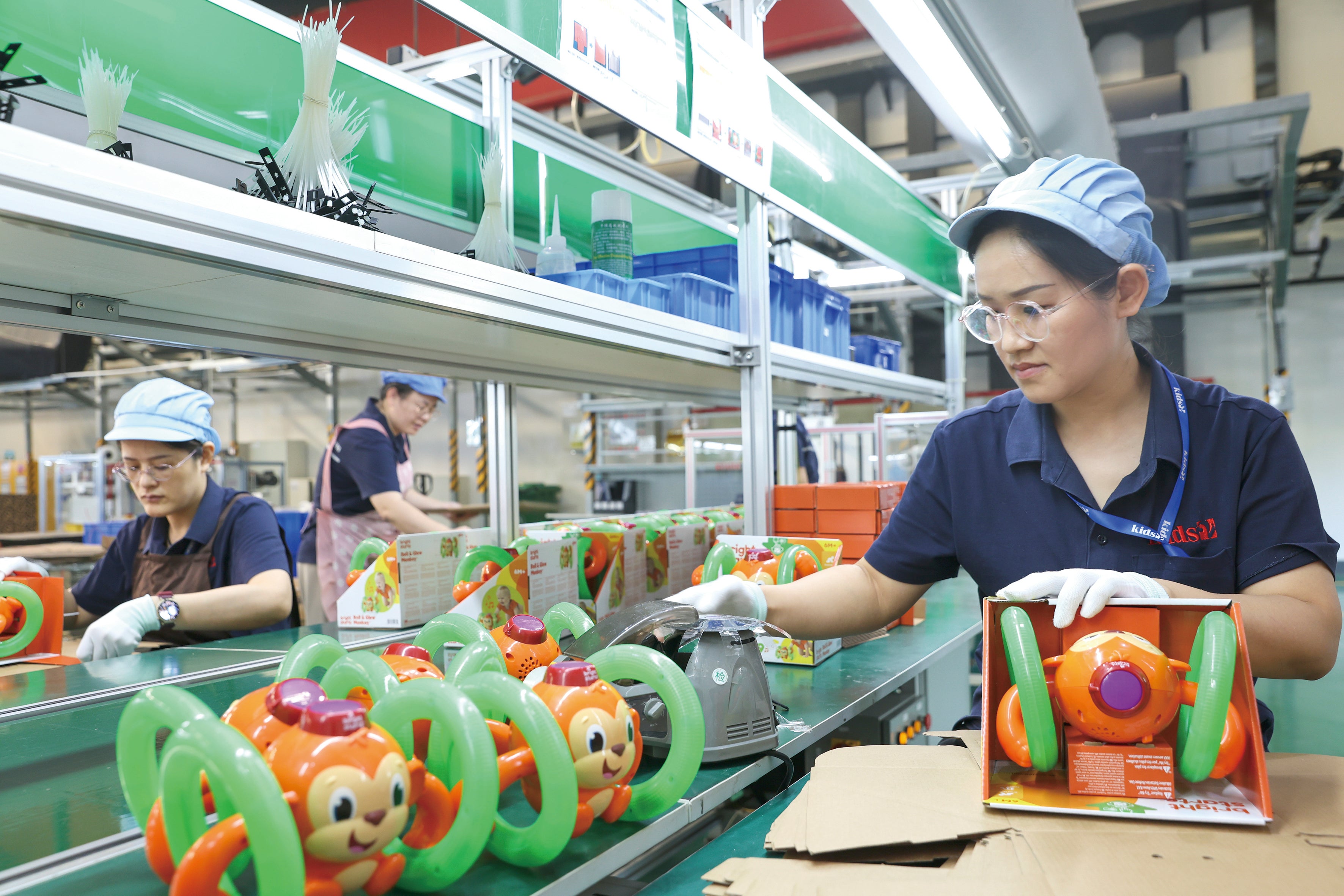 Employees work on the production line of a foreign-funded company in Jiujiang, Jiangxi province