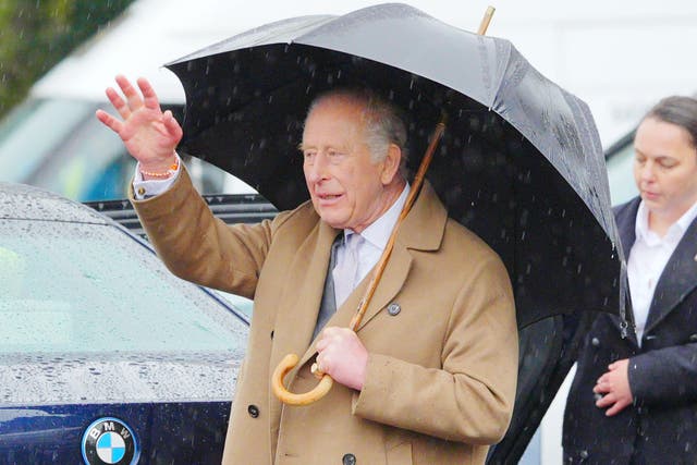 The King waves to wellwishers as he leaves after a visit to Cyfarthfa Castle in Merthyr Tydfil, South Wales (Ben Birchall/PA)
