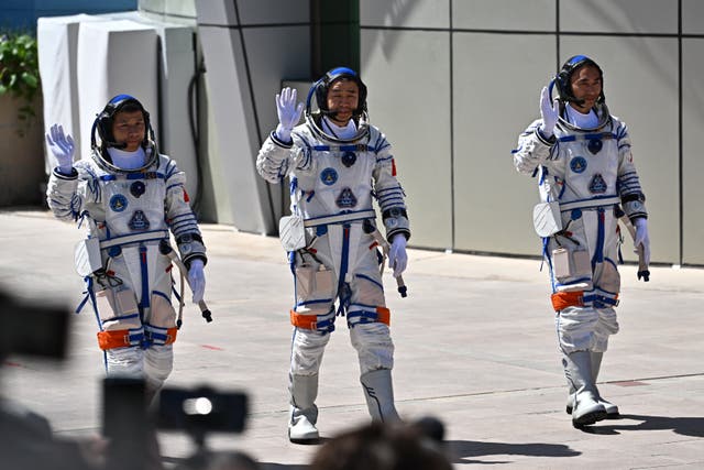 <p>Astronauts for China's Shenzhou-20 space mission (L-R) Wang Jie, Chen Dong, and Chen Zhongrui, wave during a departure ceremony</p>