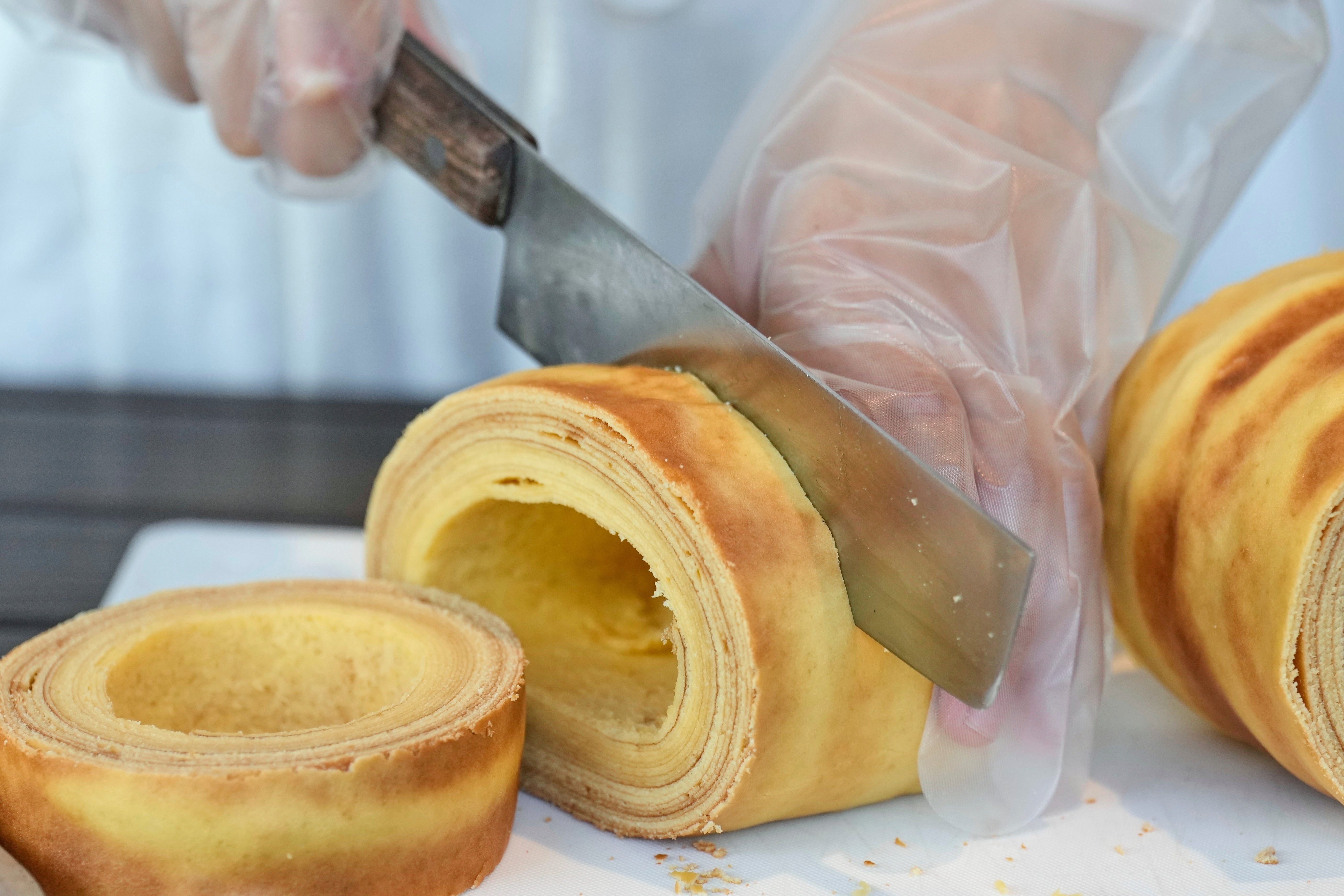 Participants cut Baumkuchen on Ninoshima