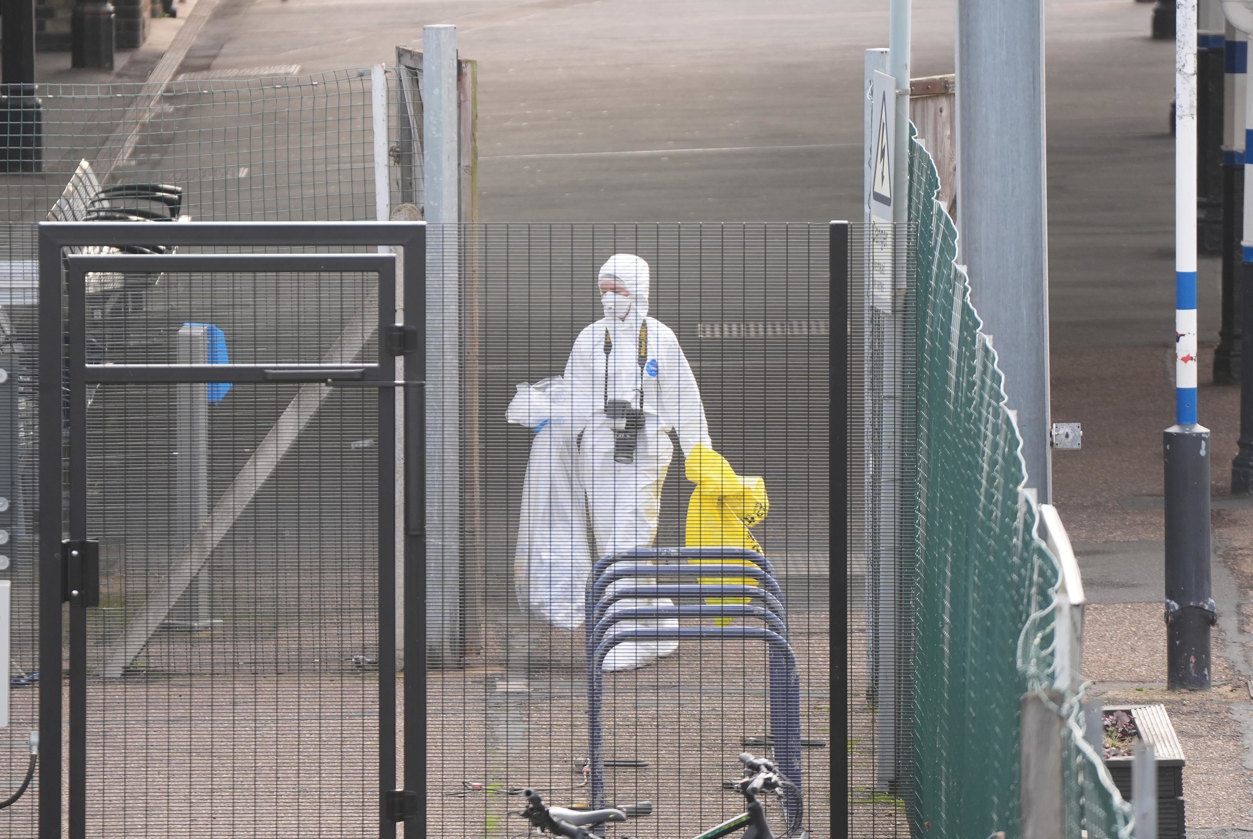 <p>A forensic investigator at Huntingdon train station in Cambridgeshire</p>