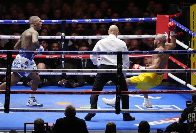 <p>Benn knocks down Eubank Jr in the 12th round (Nick Potts/PA)</p>