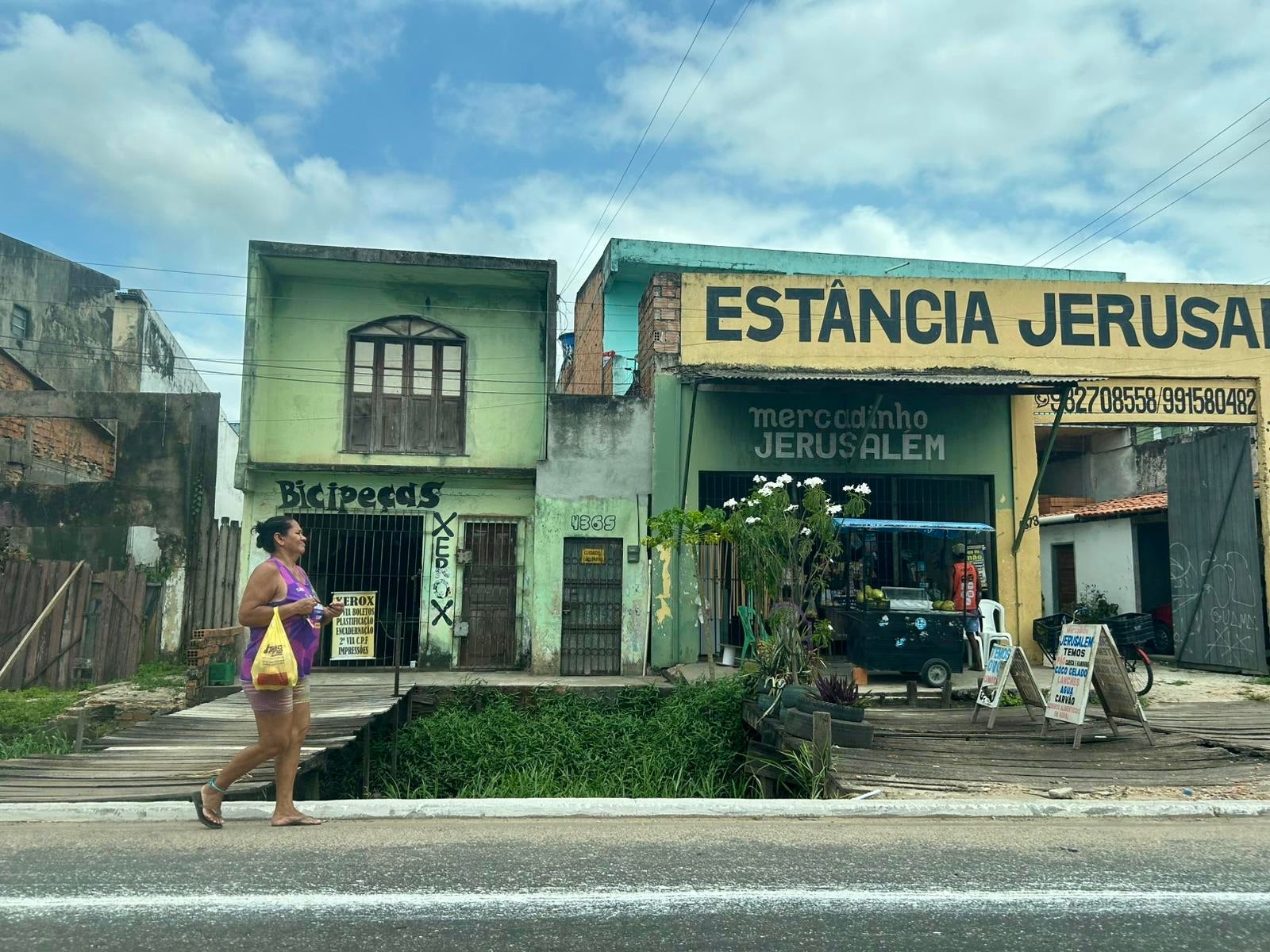 A lady walks through the midday heat in one of Belém’s many baixadas, which is the local name for favela areas