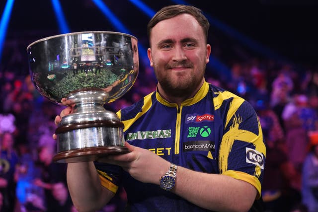Littler lifts the trophy after winning the Grand Slam of Darts final (Martin Rickett/PA)