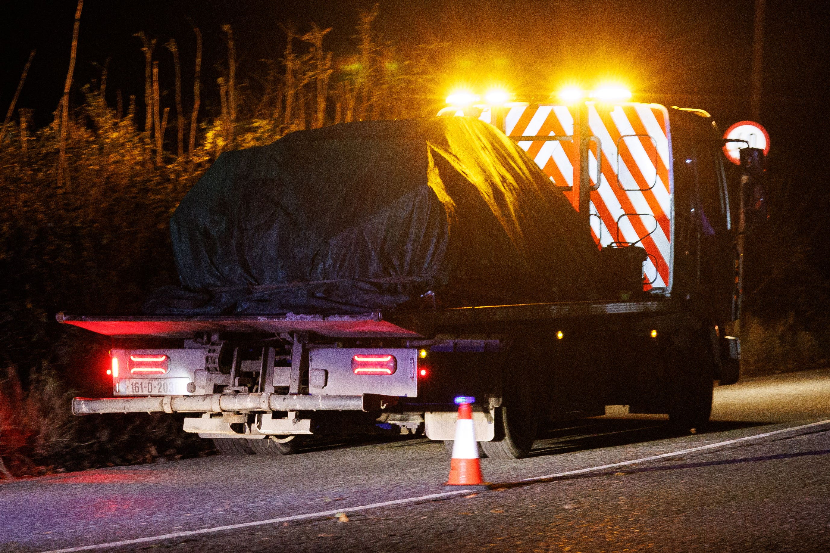 A vehicle is removed on a recovery truck from the scene on the L3168 just outside Dundalk, Co Louth (Damien Eagers/PA)