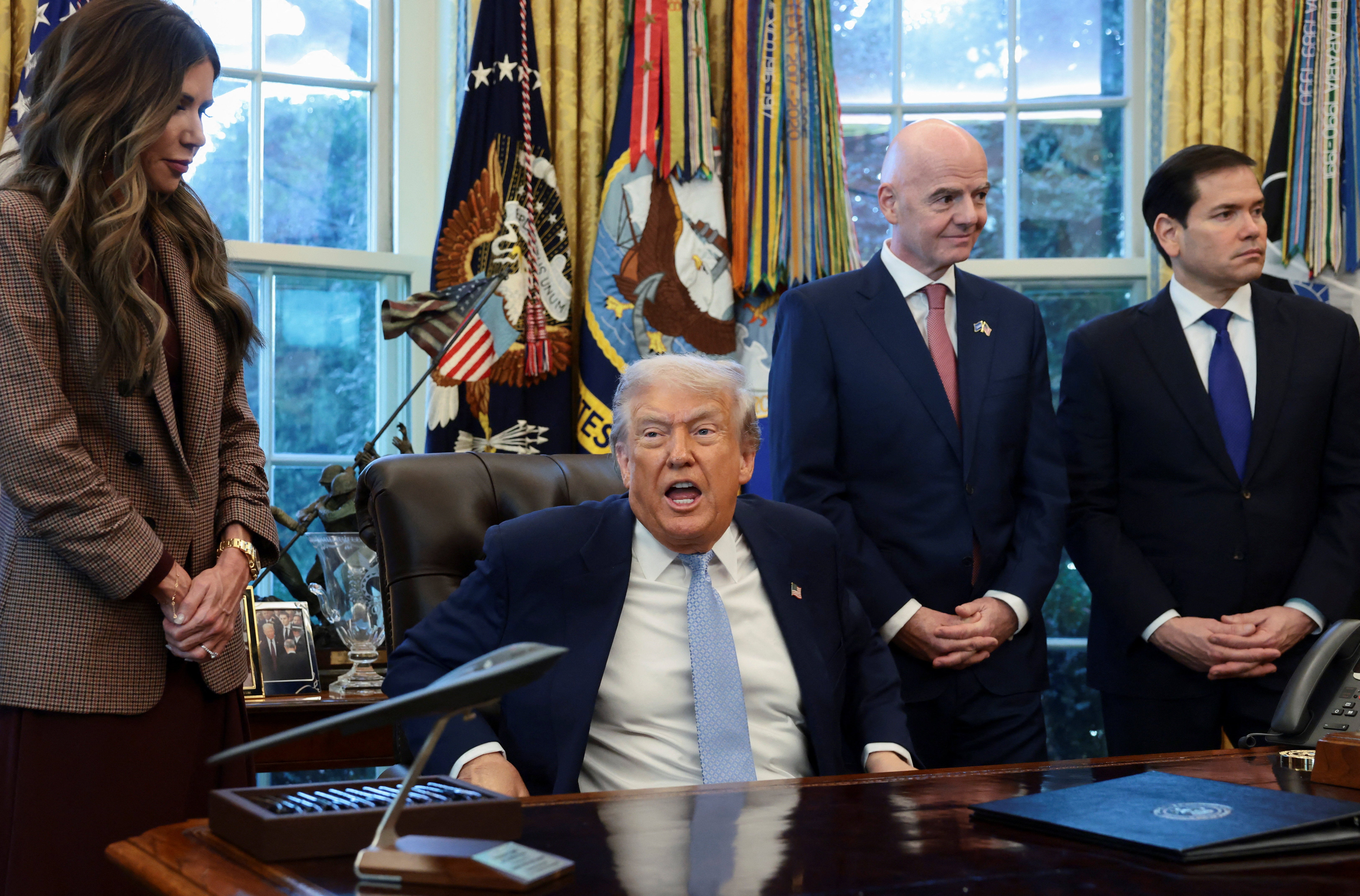 <p>U.S. President Donald Trump speaks while U.S. Homeland Security Secretary Kristi Noem, FIFA President Gianni Infantino and U.S. Secretary of State Marco Rubio stand by his side, as he meets with the White House Task Force on the FIFA World Cup 2026 in the Oval Office at the White House in Washington, D.C., U.S., November 17, 2025. REUTERS/Evelyn Hockstein</p>