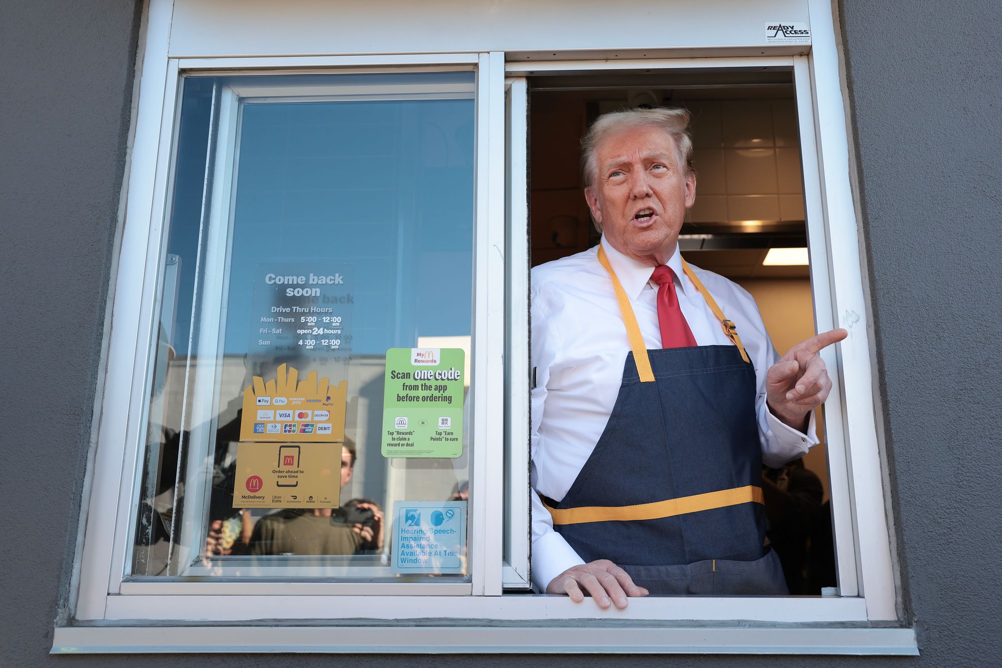 <p>Then-presidential nominee Donald Trump answers questions as he works the drive-through line during a campaign photo op as he visits a McDonald's restaurant on October 20, 2024, in Feasterville-Trevose, Pennsylvania</p>