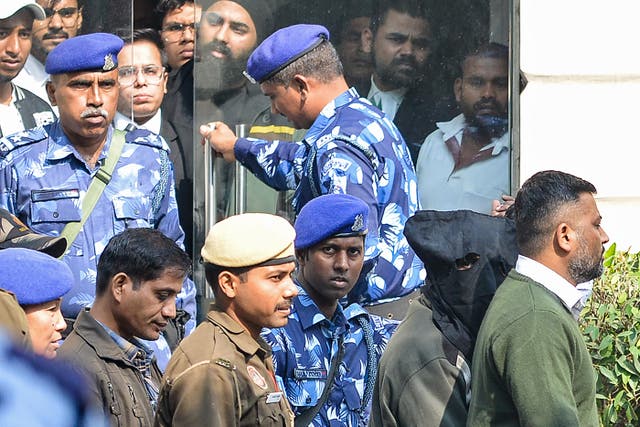 <p>Security personnel escort alleged car blast accused (2R) with his face covered in black cloth, at the Patiala House Court in New Delhi on 17 November 2025, a day after he was detained</p>
