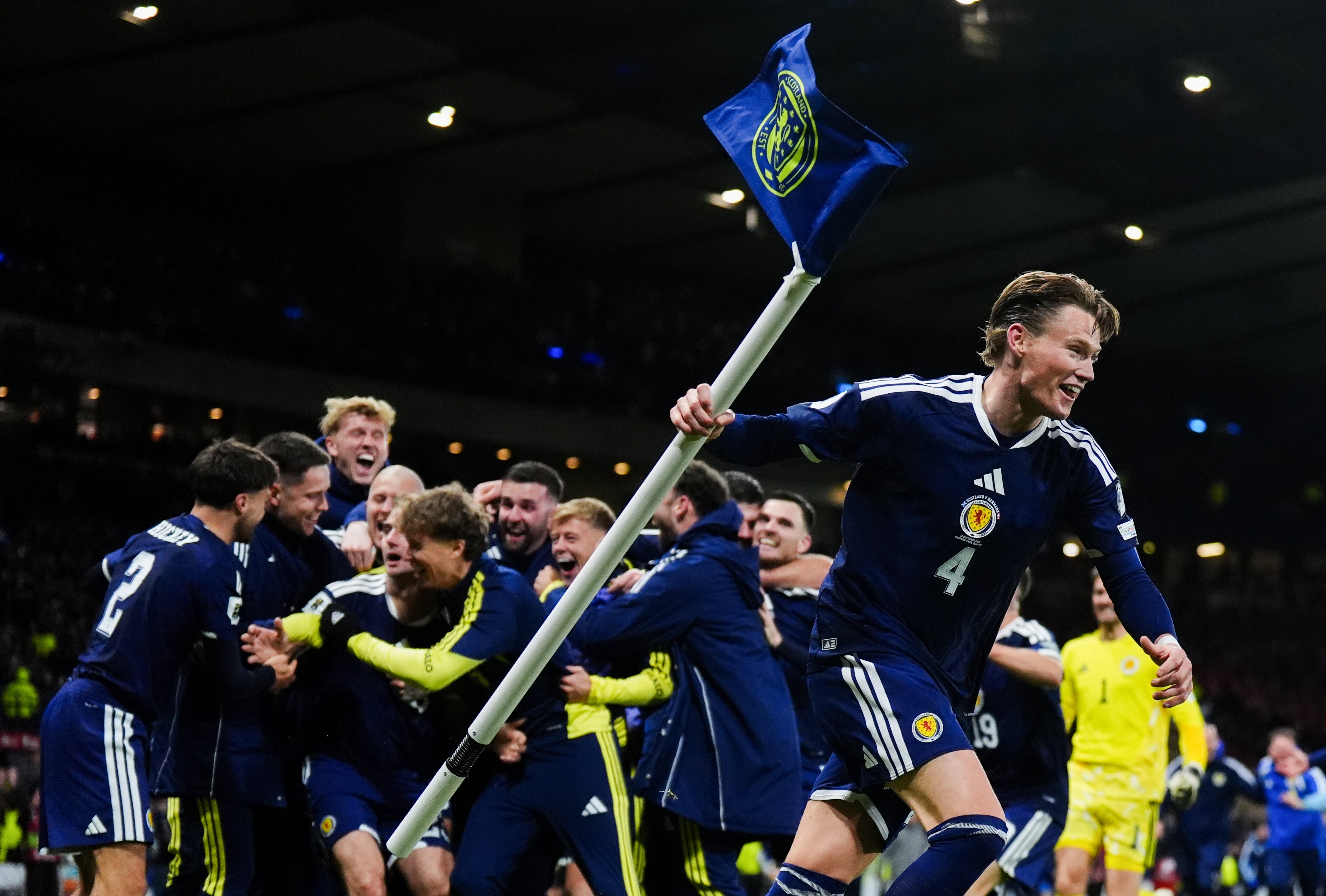 Scotland players celebrate after Kenny McLean’s goal from the halfway line deep into injury time against Denmark sealed Scotland’s place in the World Cup (Andrew Milligan/PA)