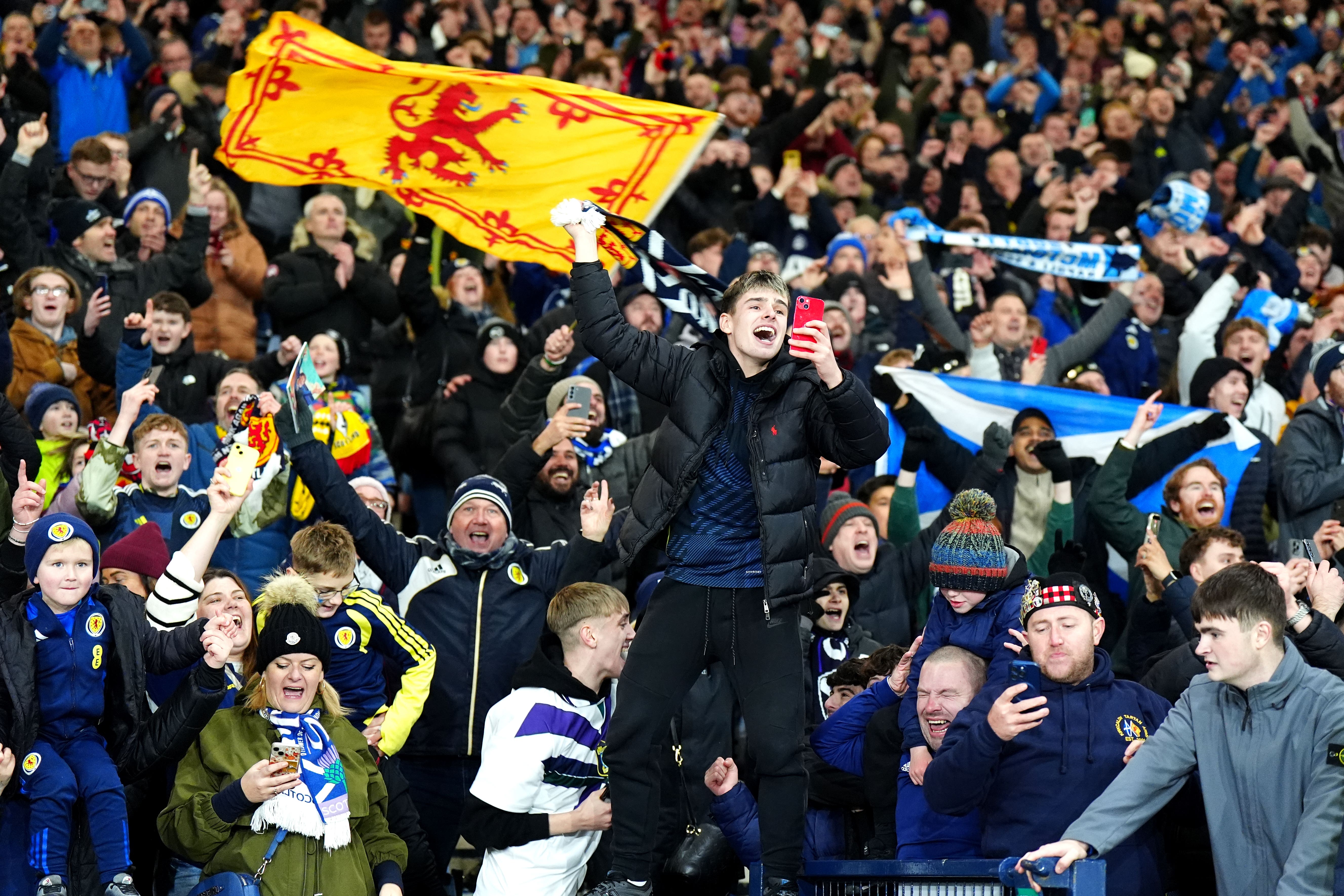 Scotland fans celebrate after they qualified for the 2026 World Cup (Jane Barlow/PA)