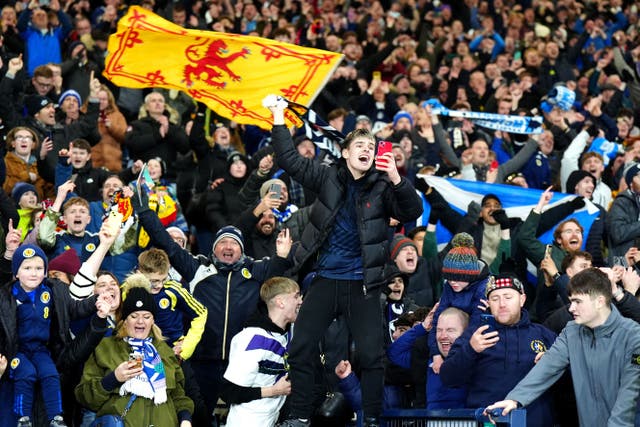Scotland fans celebrate after they qualified for the 2026 World Cup (Jane Barlow/PA)