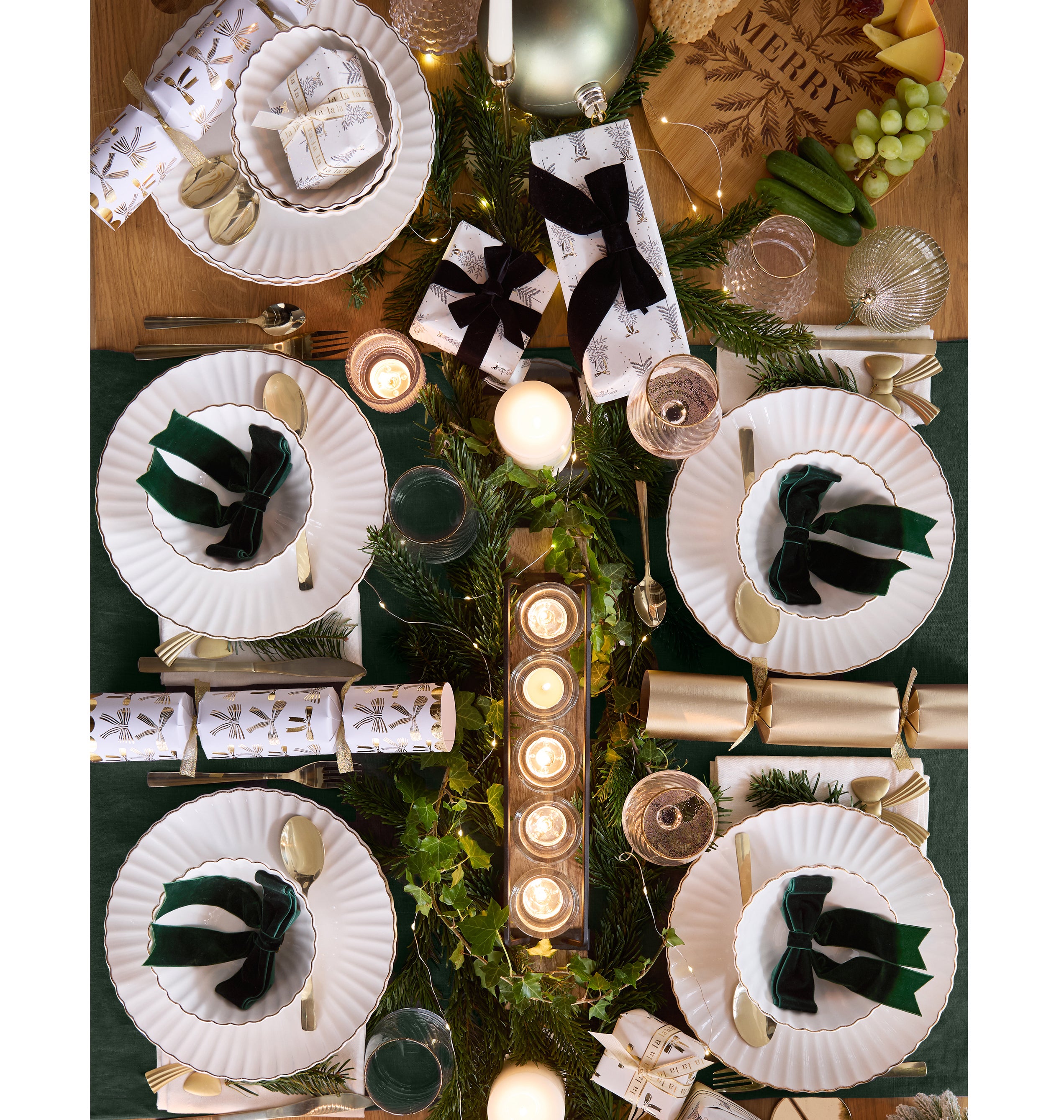 Metallic Rim Scalloped Edge Dinner Plate, £3.50; Metallic Rim Scalloped Edge Cereal Bowl, £2.50; Gold Bow Crackers, £8; Ripple Gold Rim Wine Glass – 2pk, £7; Green Bows – 6pk, £3; Tealight Holder on Wooden Stand, £8, rest of items from a selection, B&M Home, in-store