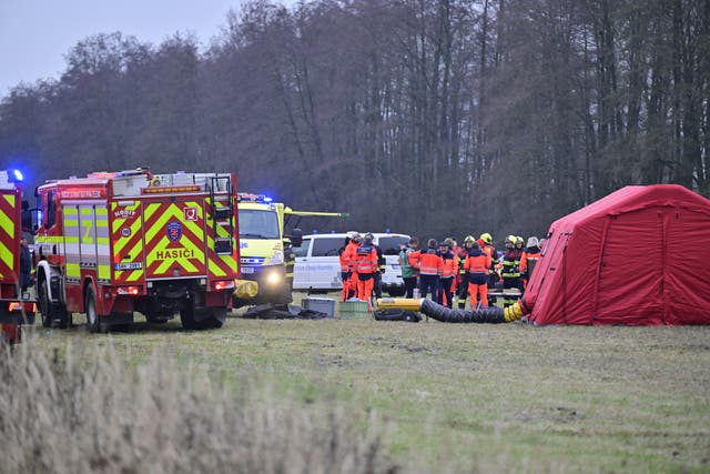 <p>Rescuers at the scene after an express train collided with a passenger train on the line between Zliv and Dívčice in the České Budějovice region in the southern Czech Republic on Thursday, Nov.20, 2025. (Vaclav Pancer/CTK via AP)</p>