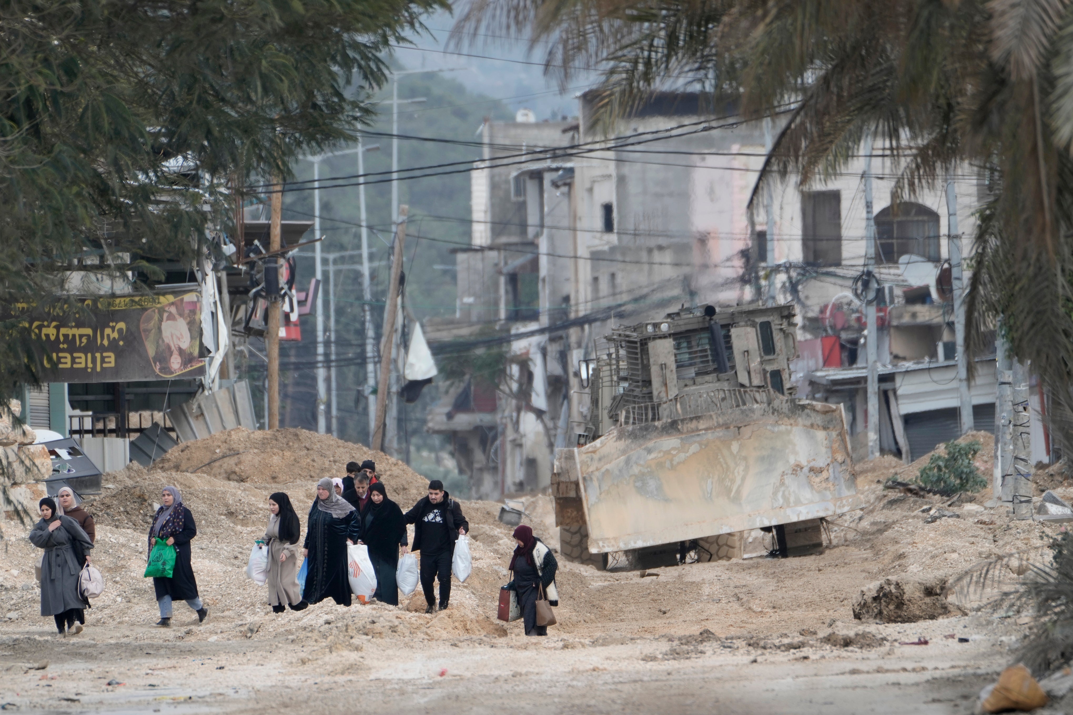 <p>Residents of the West Bank refugee camp of Nur Shams, near Tulkarem, evacuate their homes as the Israeli military continues its operation in the area on 11 February 2025</p>