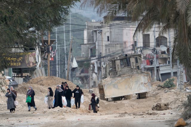 <p>Residents of the West Bank refugee camp of Nur Shams, near Tulkarem, evacuate their homes as the Israeli military continues its operation in the area on 11 February 2025</p>