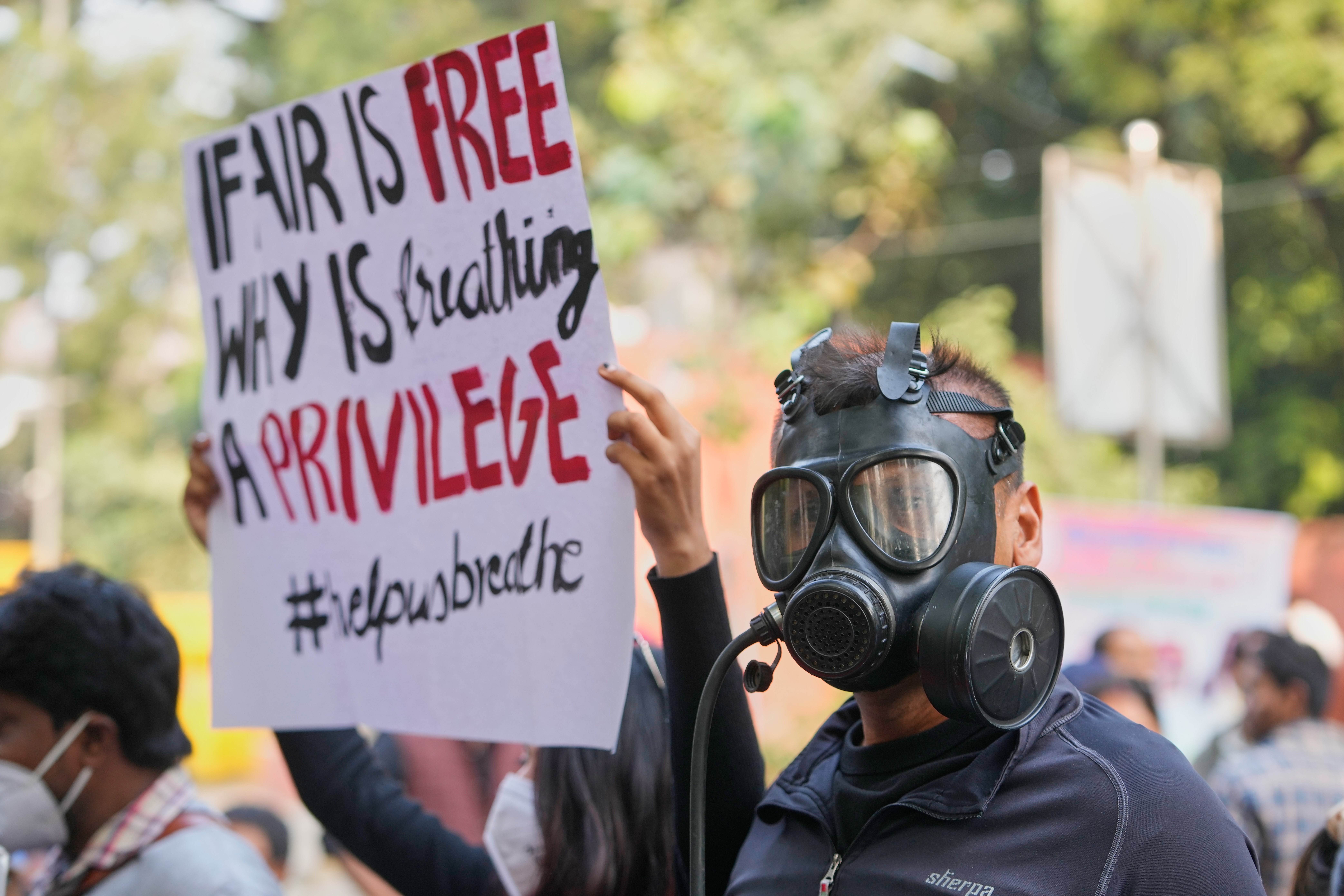 People shout slogans during a protest against a lack of action to combat air pollution in Delhi