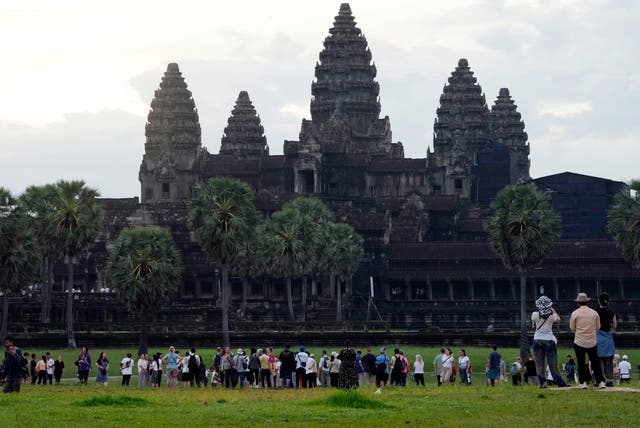 <p>FILE - Tourists wait for sunrise at the Angkor Wat temple in Siem Reap province, Cambodia, Friday, Aug. 2, 2024</p>