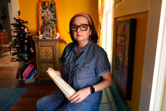 <p>Gigi Cervantes, who resigned from her position as a theater teacher at a Fort Worth school rather than teach in a classroom where the Ten Commandments are hung, poses for a photo at her home, Wednesday, Nov. 5, 2025, in Fort Worth, Texas</p>