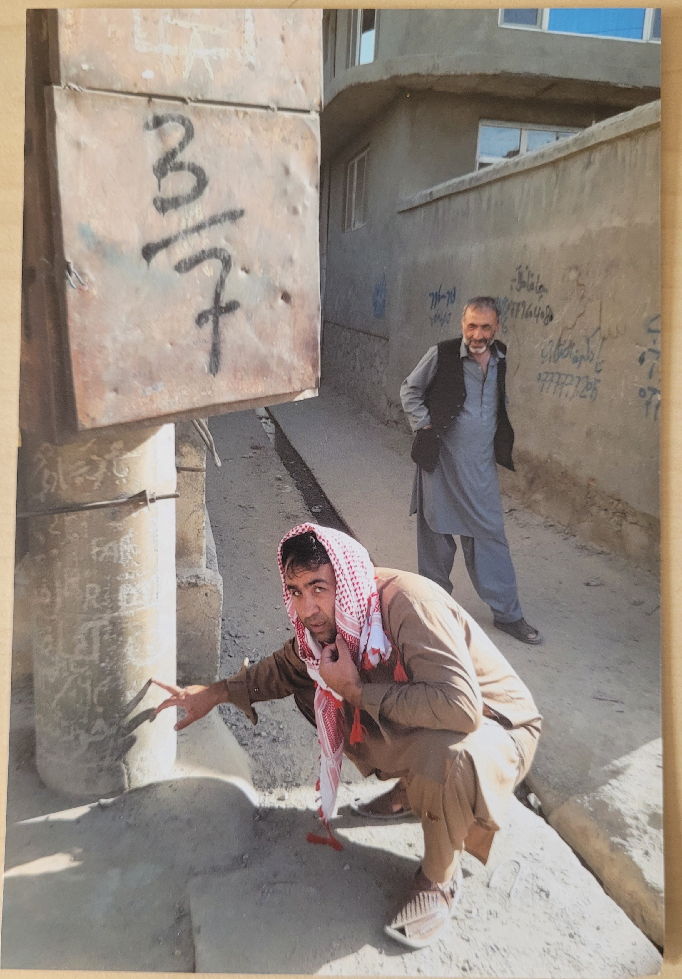 Maiwand Banayee shows the electricity pole where he had tried to carve his name in Kabul