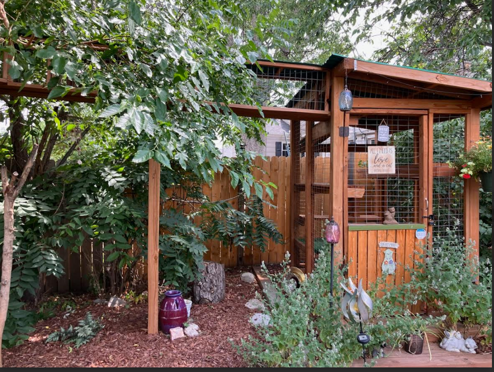 Salli Squires Cook's wooden catio in Denver has a fence to keep her cat safe and a path, which connects to her home’s garage, for the pet to run through