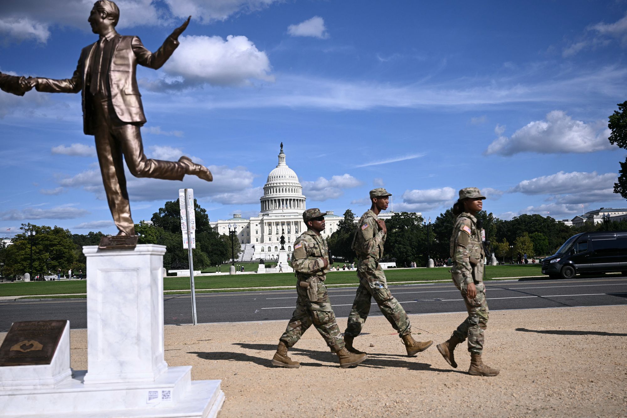 <p>Members of the National Guard patrol the National Mall in Washington, DC, next to a statue depicting US President Donald Trump and Jeffrey Epstein holding hands near the US Capitol on October 2, 2025</p>