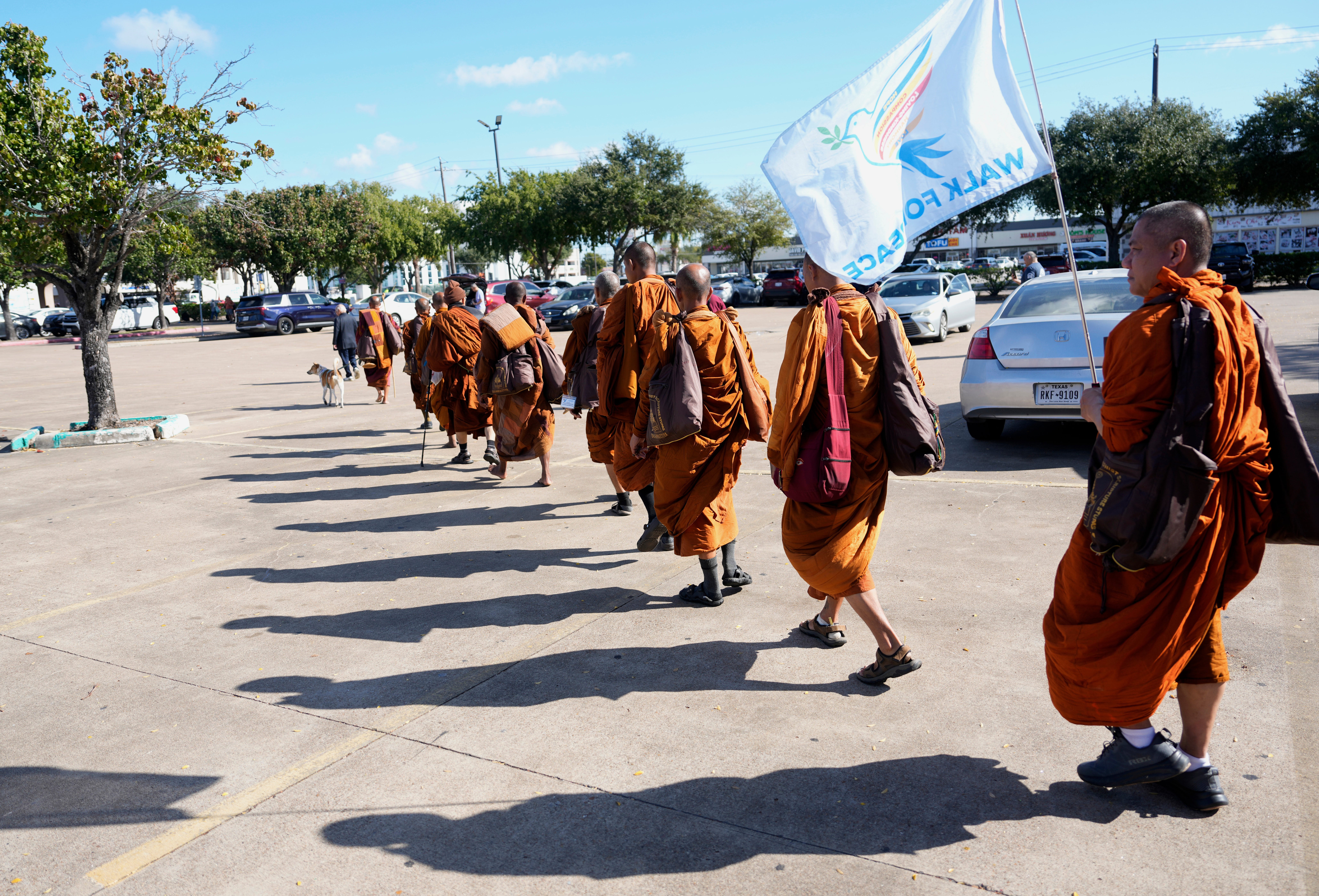 The Buddhist monks from the Huong Dao Vipassana Bhavana Center in Fort Worth, who are undertaking a 2,300 mile pilgrimage of "Walk for Peace," arrive for a welcome ceremony at Hong Kong City Mall in Houston, Friday, Nov. 14, 2025. (Melissa Phillip/Houston Chronicle via AP)