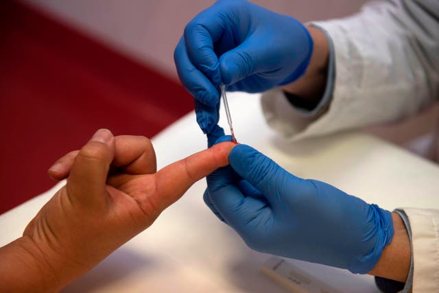 <p>Person undergoes a finger prick blood sample collection</p>