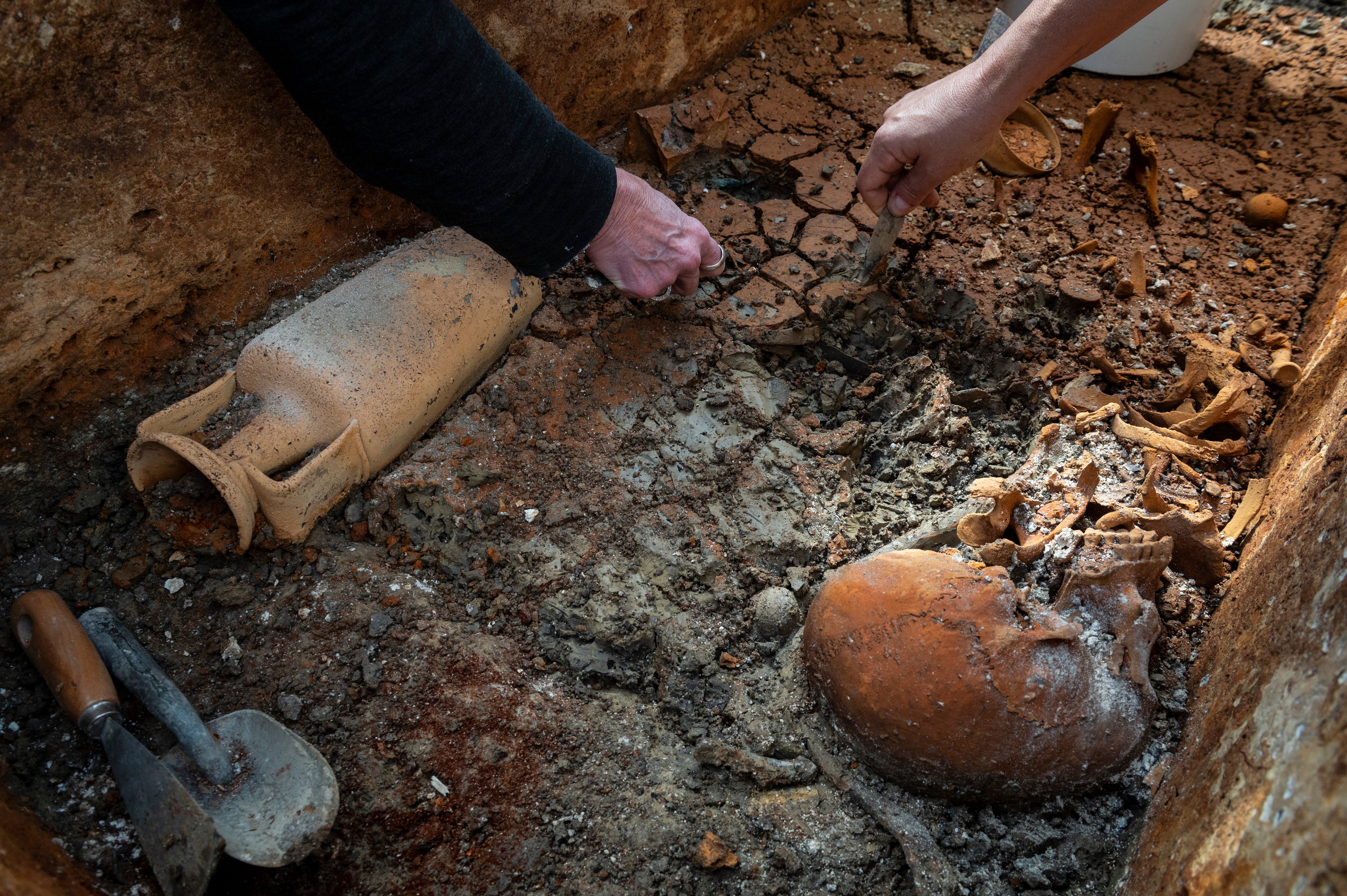 This photo released by Budapest History Museum shows researchers removing clay from an intact Roman sarcophagus at an archeological site in Budapest, Hungary, Sept. 30, 2025. (Gabor Lakos, Budapest History Museum via AP)