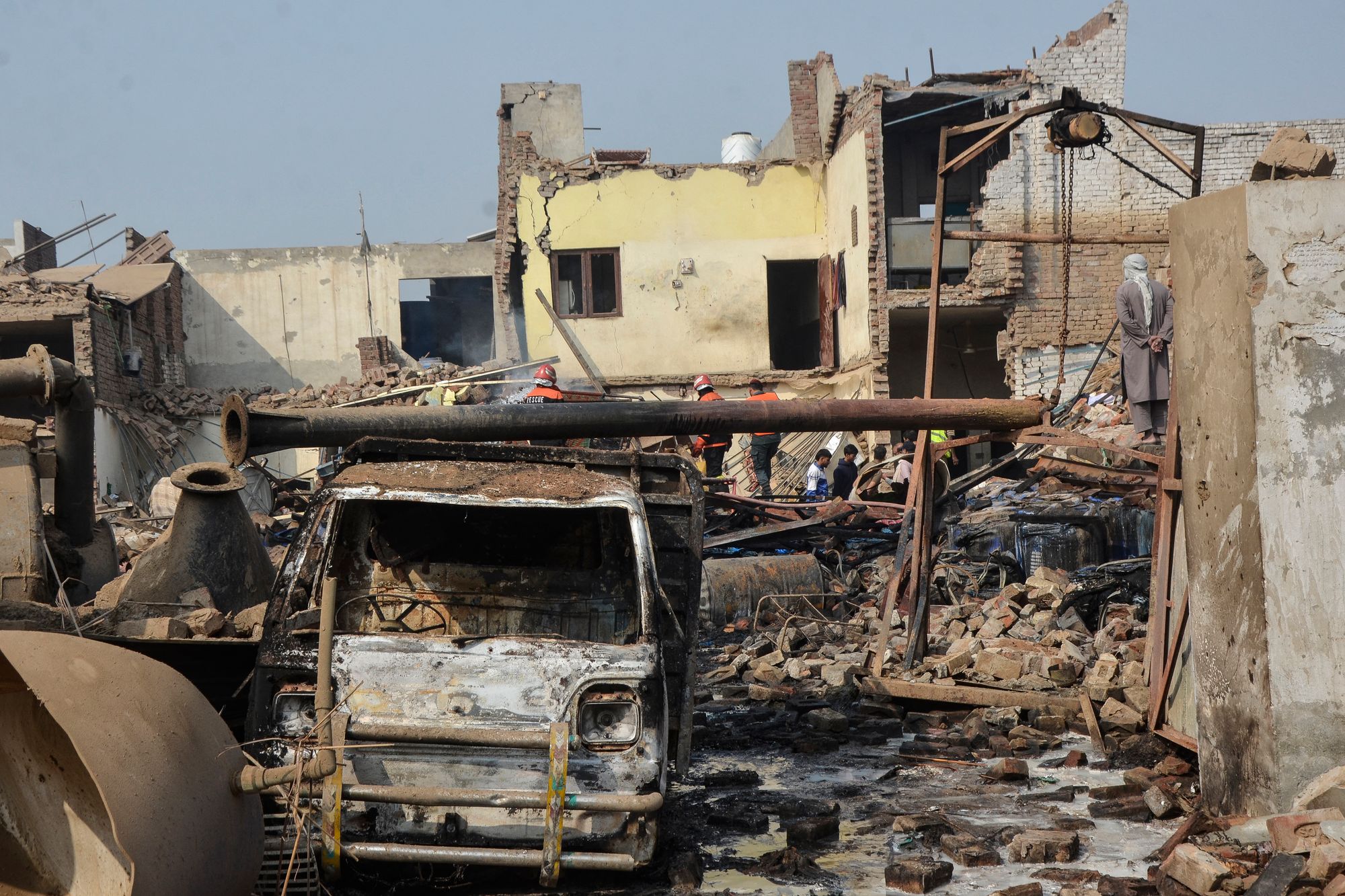 Rescue workers search for survivors after an explosion at a factory in Faisalabad, Pakistan, on 21 November 2025