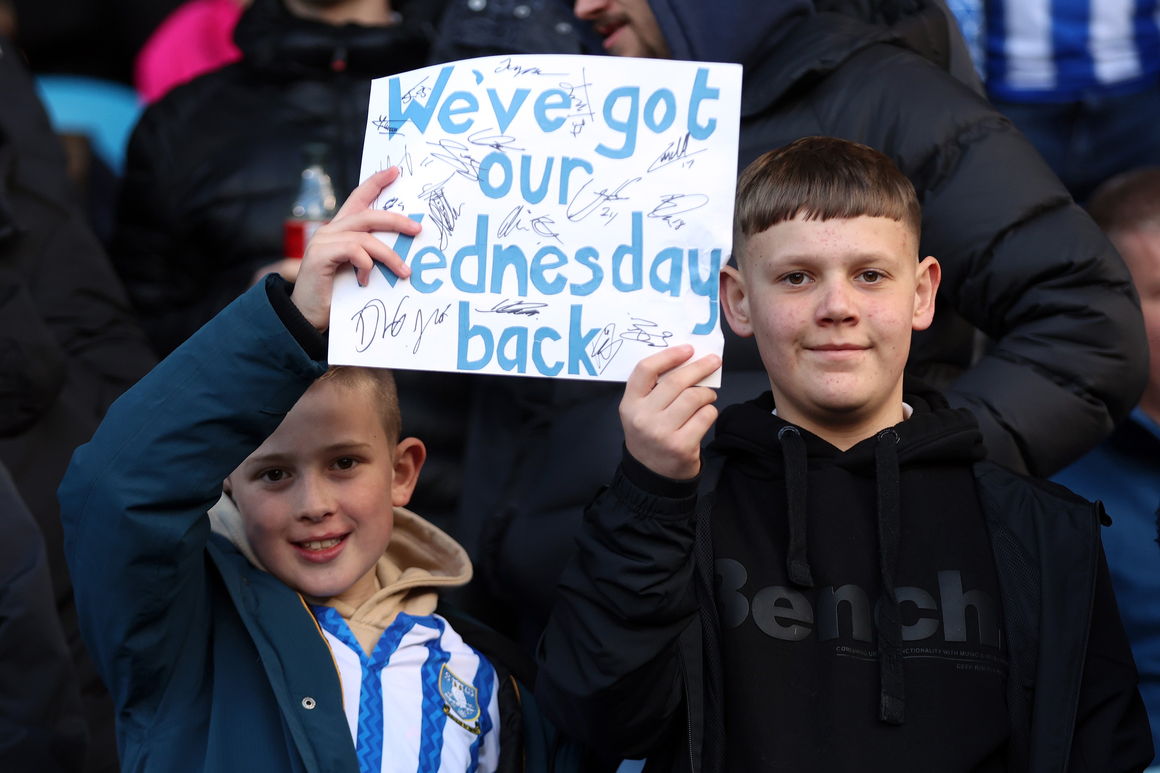 Young Sheffield Wednesday fans celebrate the departure of owner Dejphon Chansiri