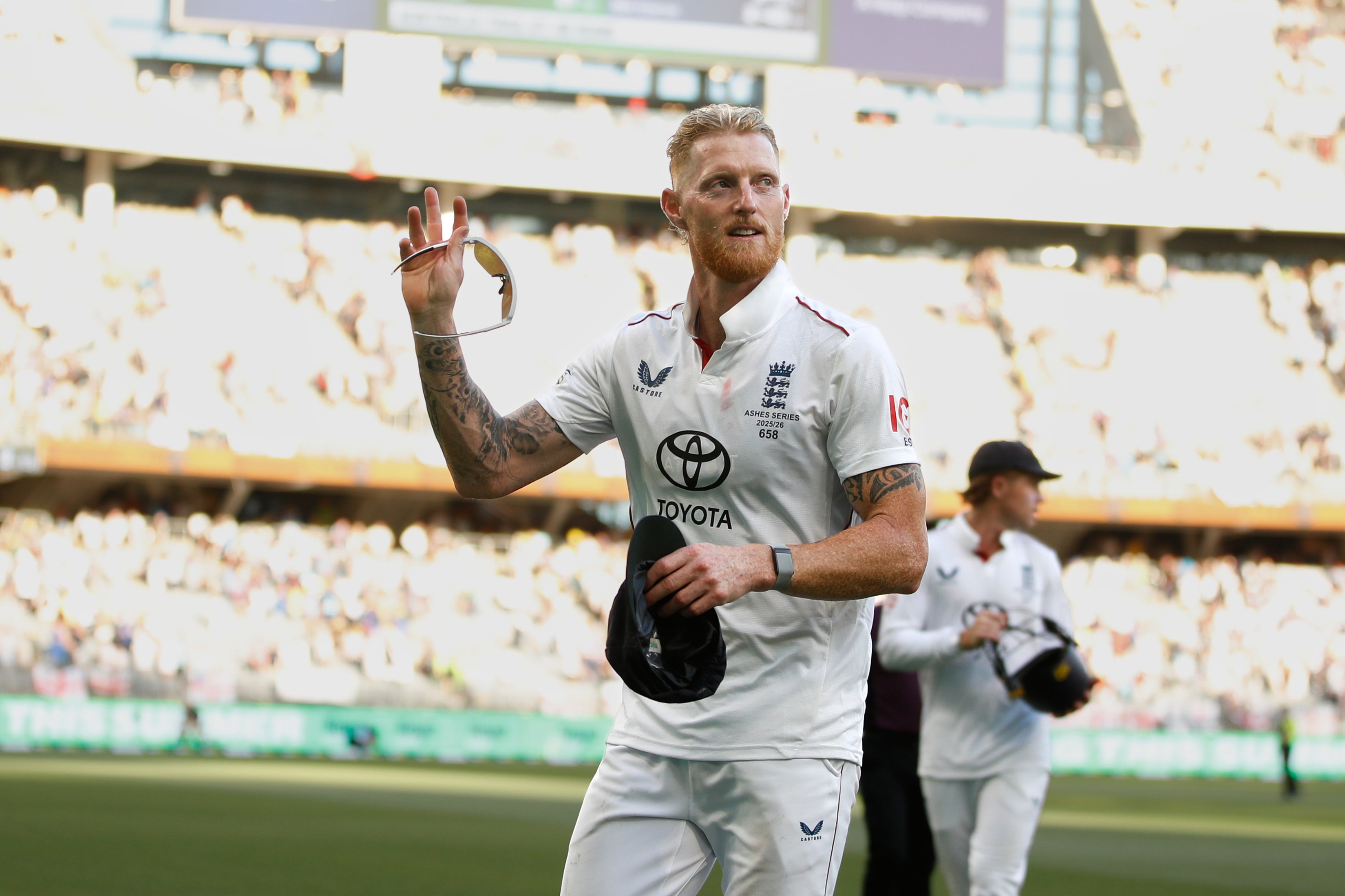 England's captain Ben Stokes acknowledges the fans as he walks out with the teammates