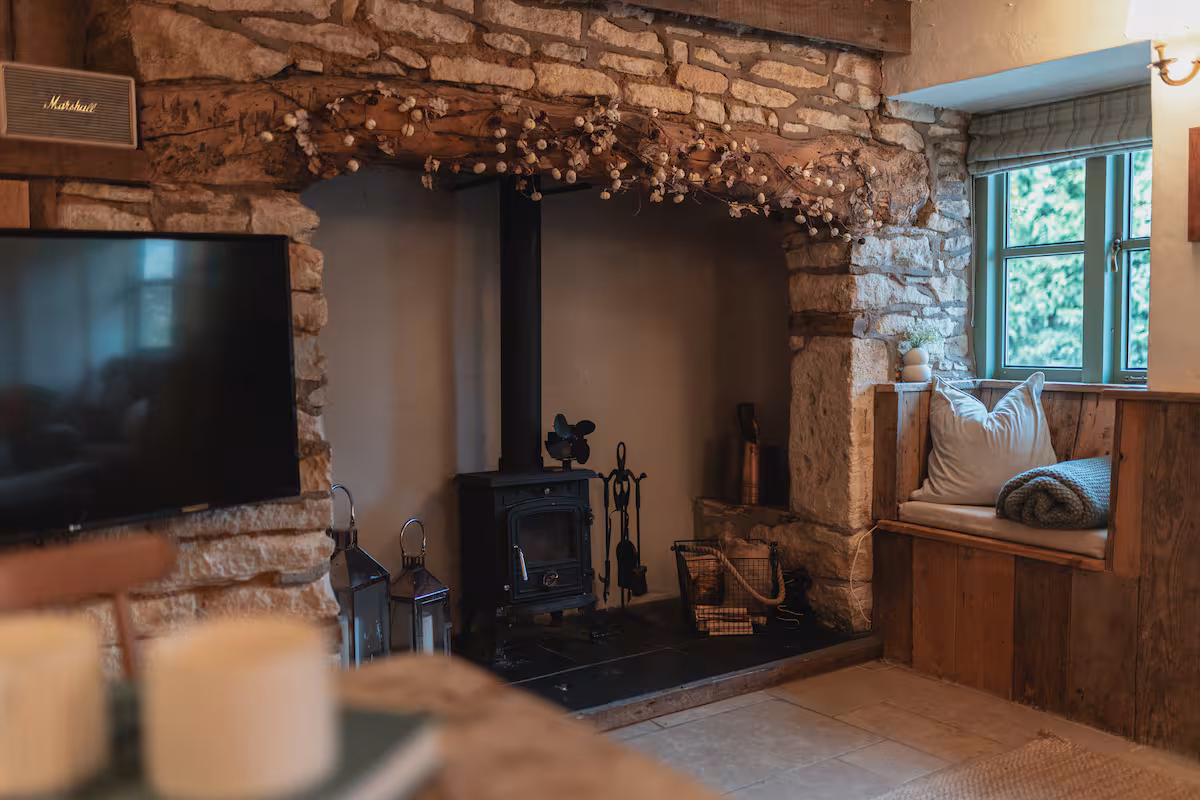 Stone cladding and wooden beams make this cottage cosy