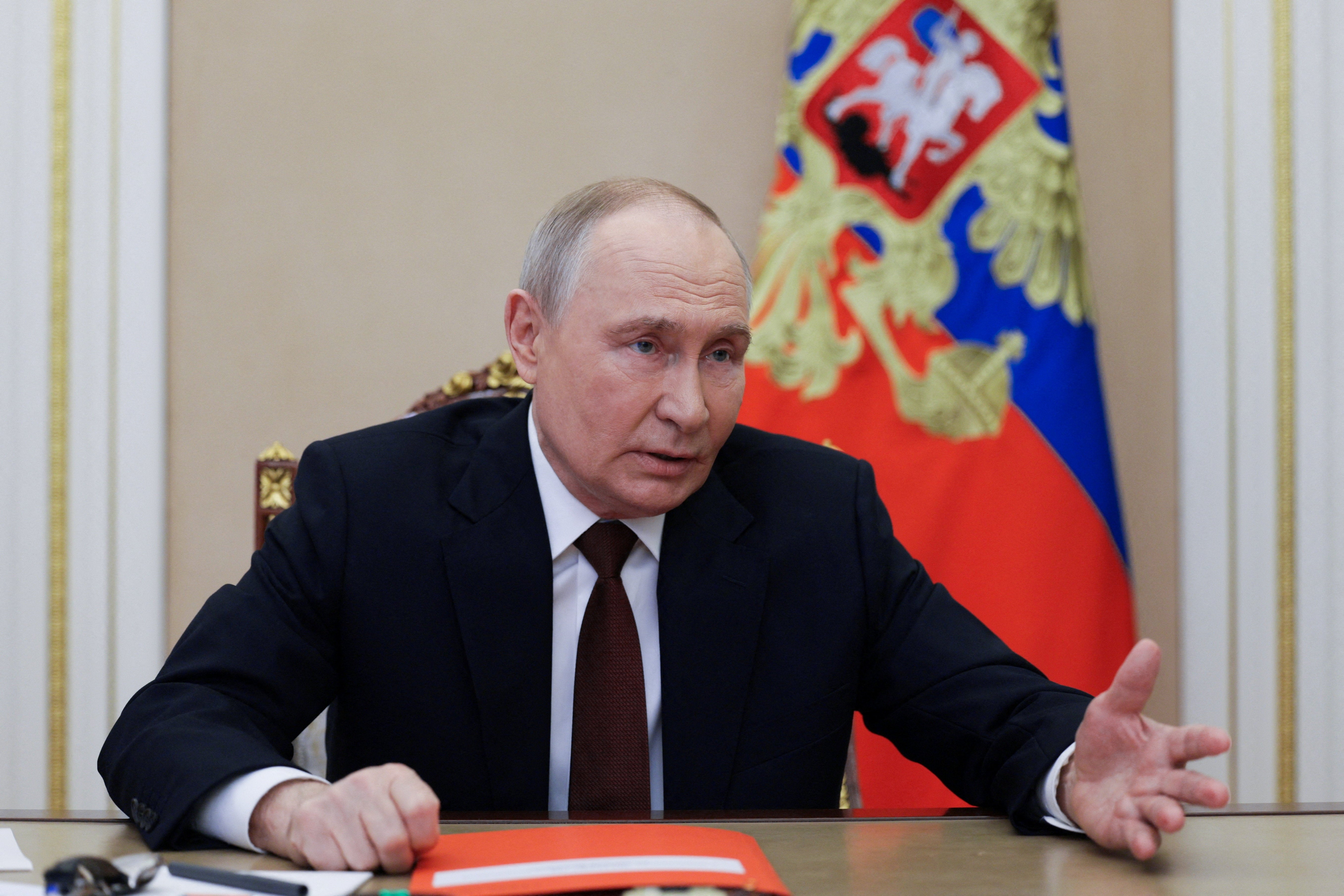 Russian President Vladimir Putin chairs a meeting with members of the Security Council via video link