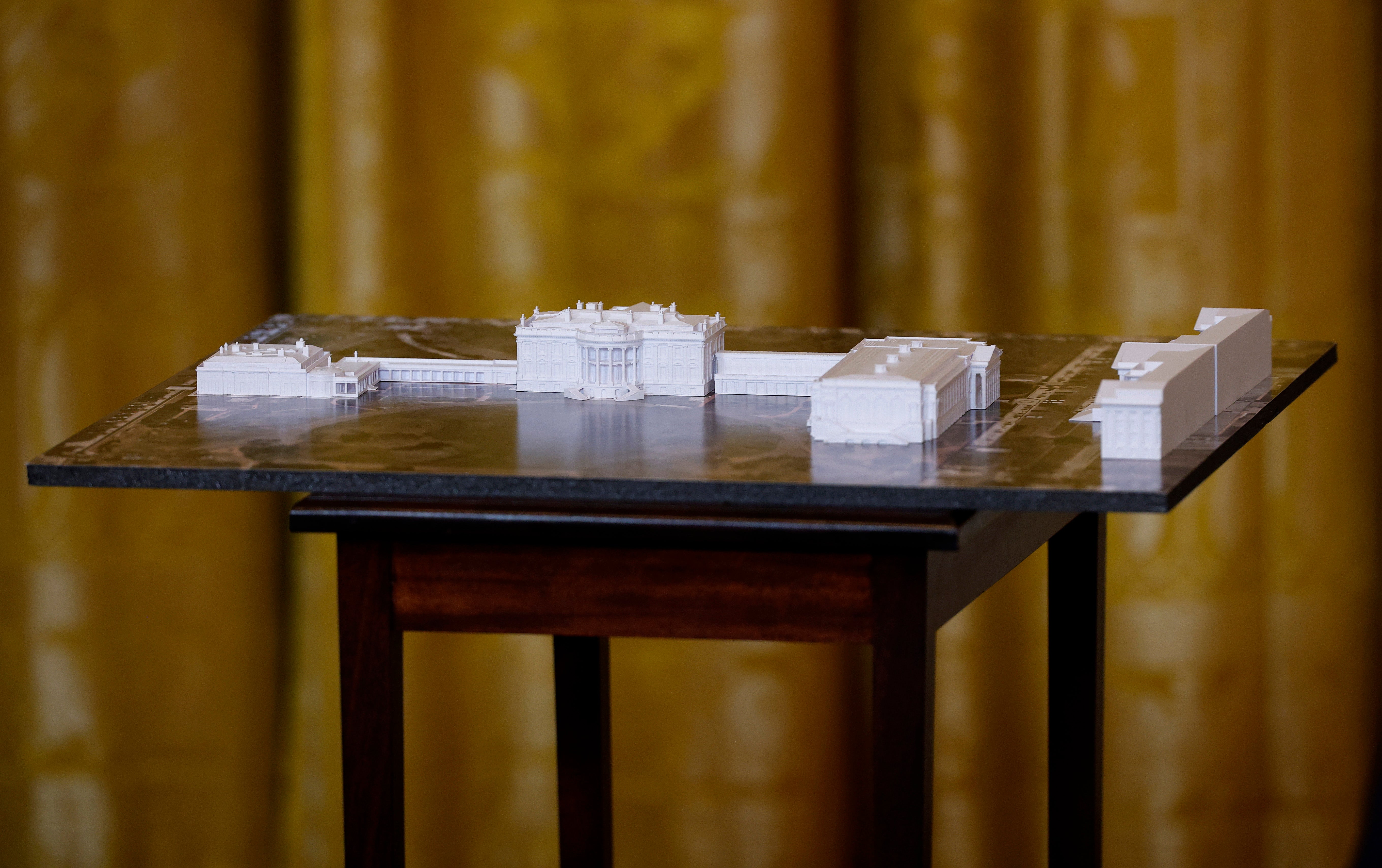A model of the White House and Trump's ballroom is displayed during a fundraising dinner on October 15