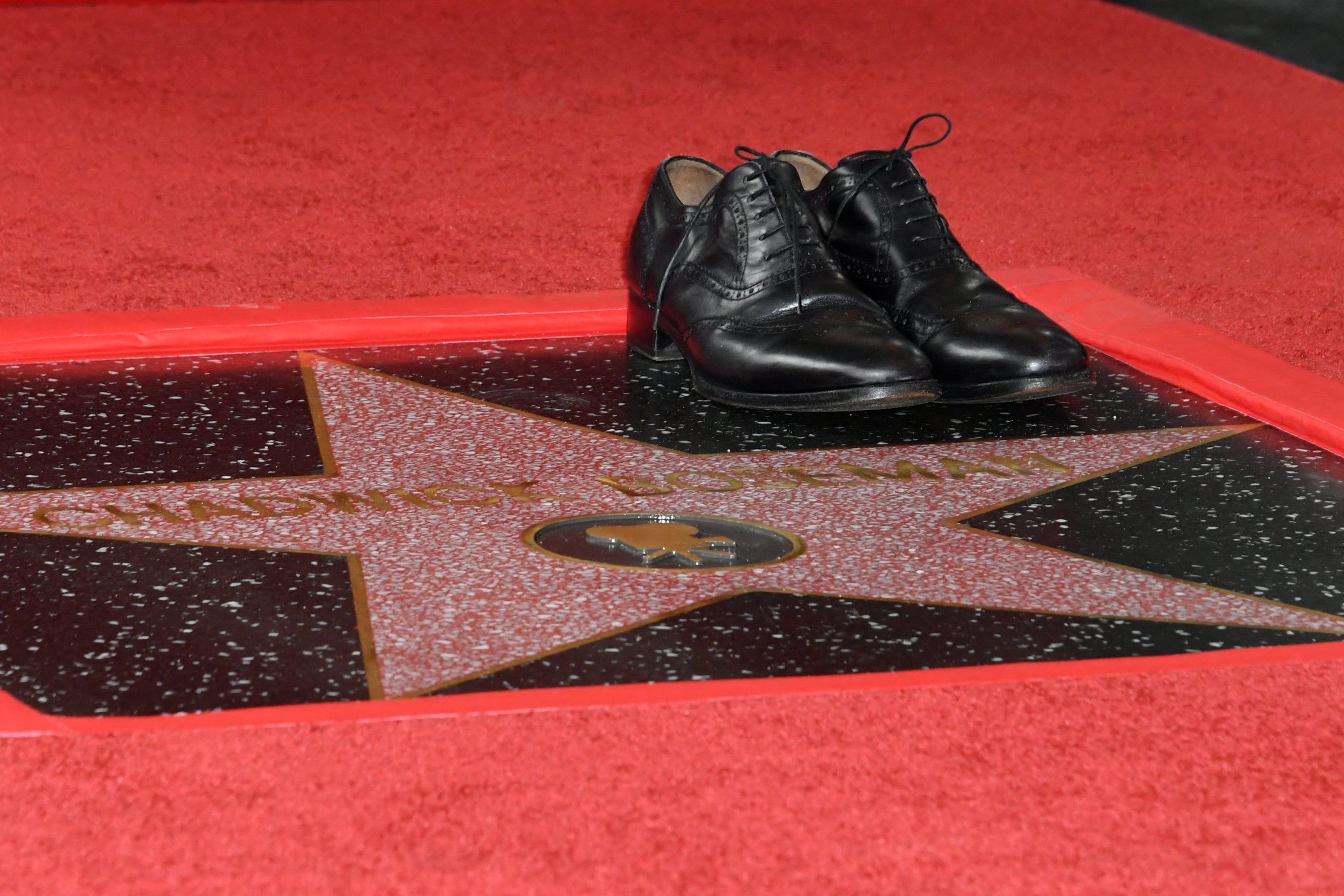 Boseman’s widow placed a pair of his shoes beside the star