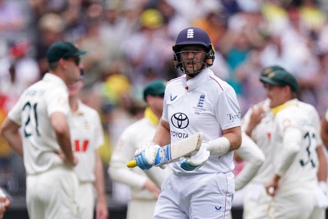 England’s Joe Root (centre) walks off after being dismissed by Australia’s Mitchell Starc (Robbie Stephenson/PA)